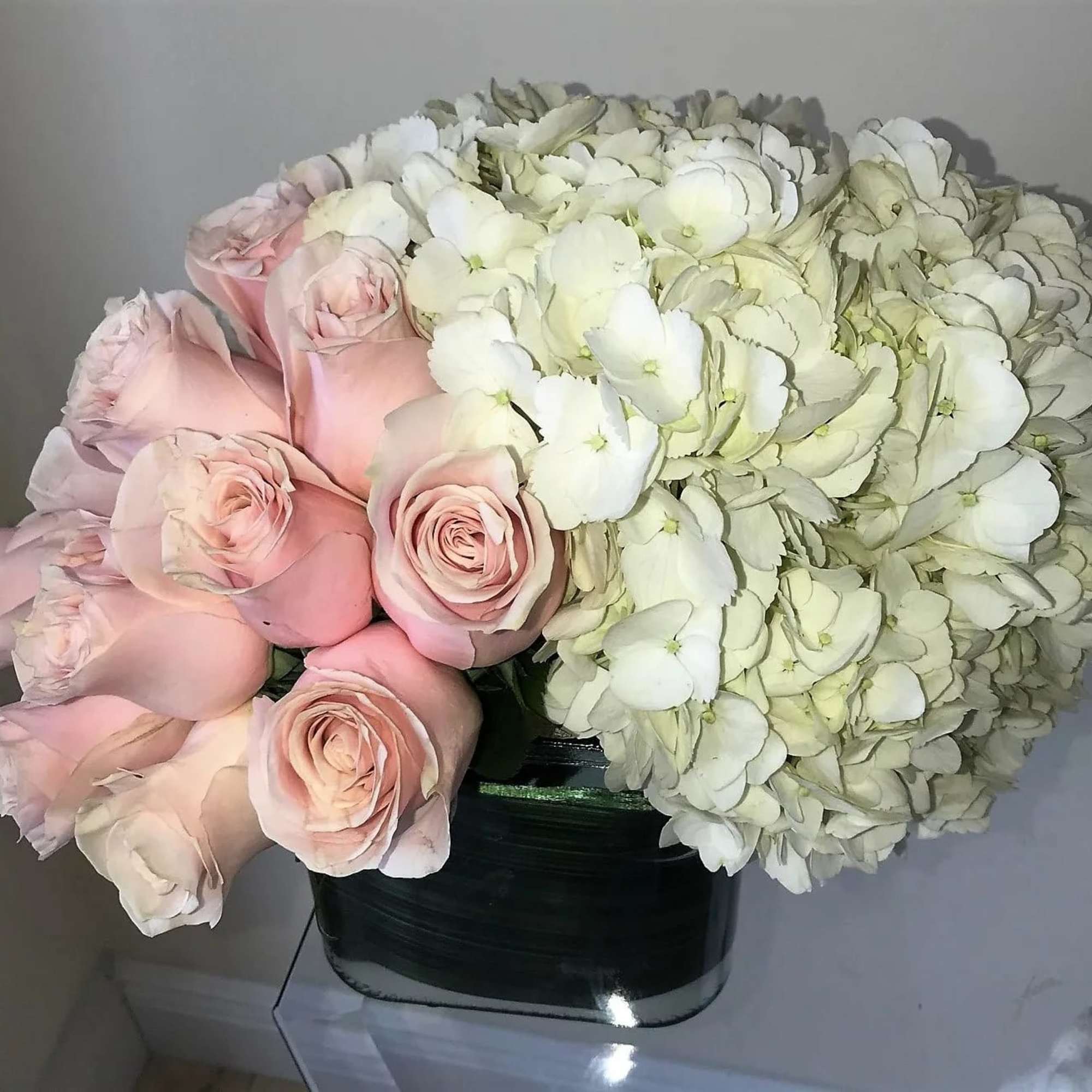 White Hydrangeas with 12 Pink Roses in a glass or white glass