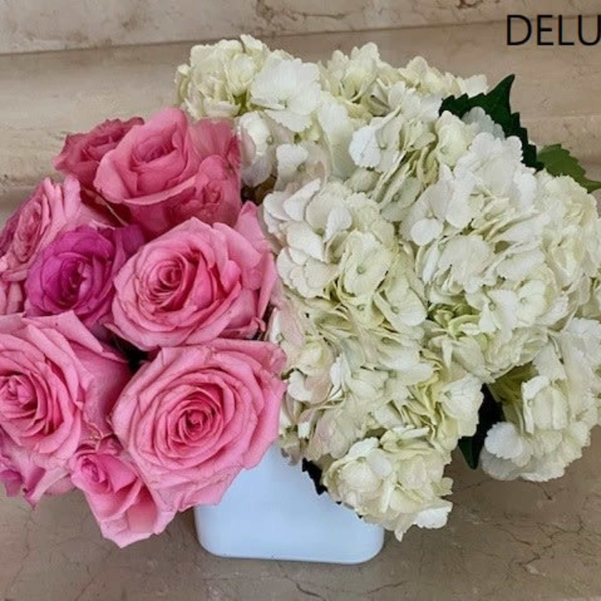 White Hydrangeas with 12 Pink Roses in a glass or white glass