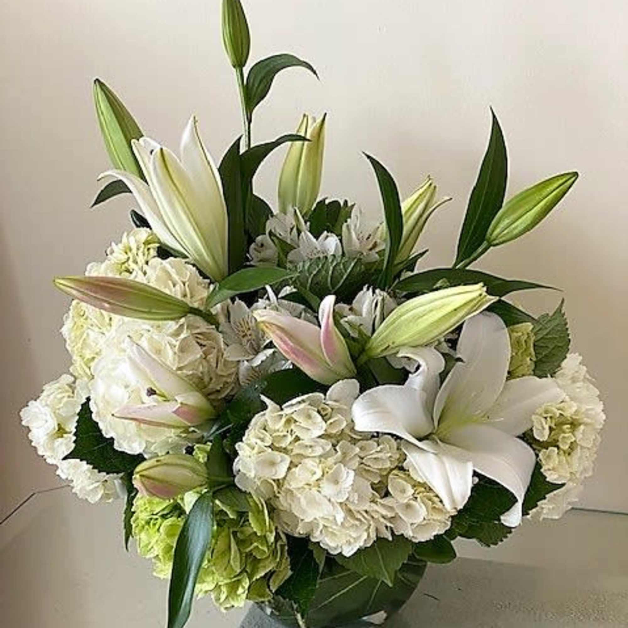 White flowers as shown arranged round in a vase. The quantity of