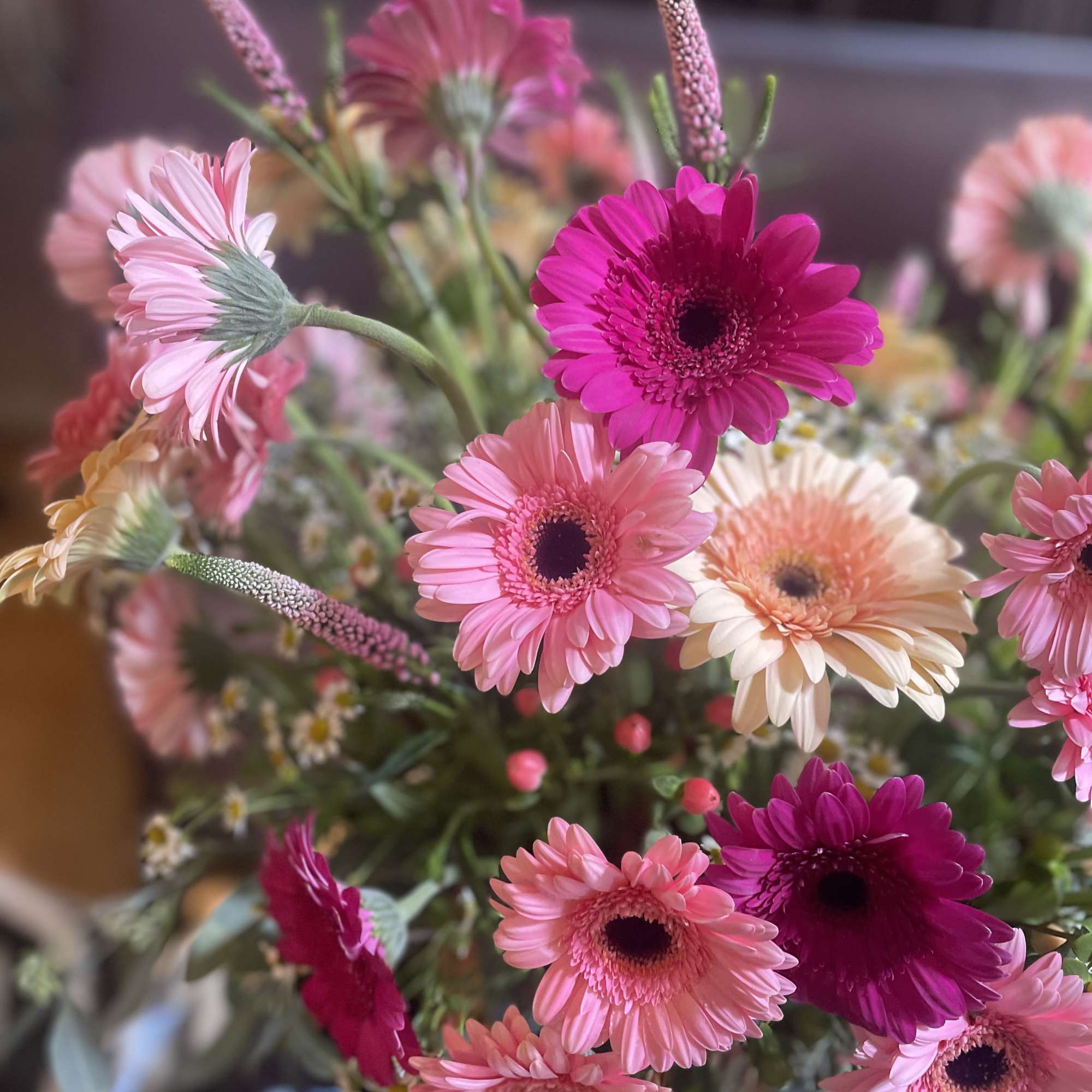 Nestled in a charming picnic basket, a vibrant flower arrangement awaits, adorned