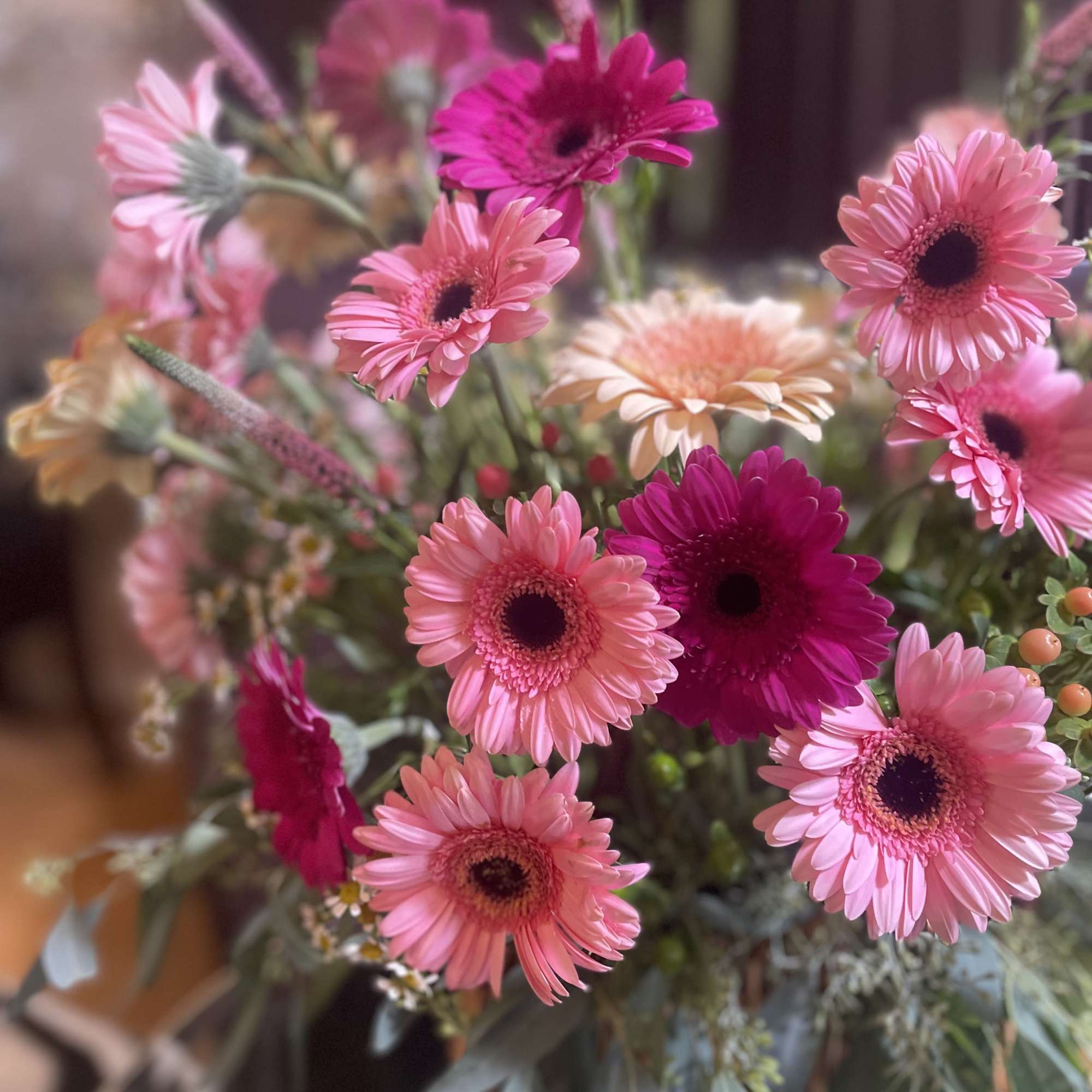 Nestled in a charming picnic basket, a vibrant flower arrangement awaits, adorned