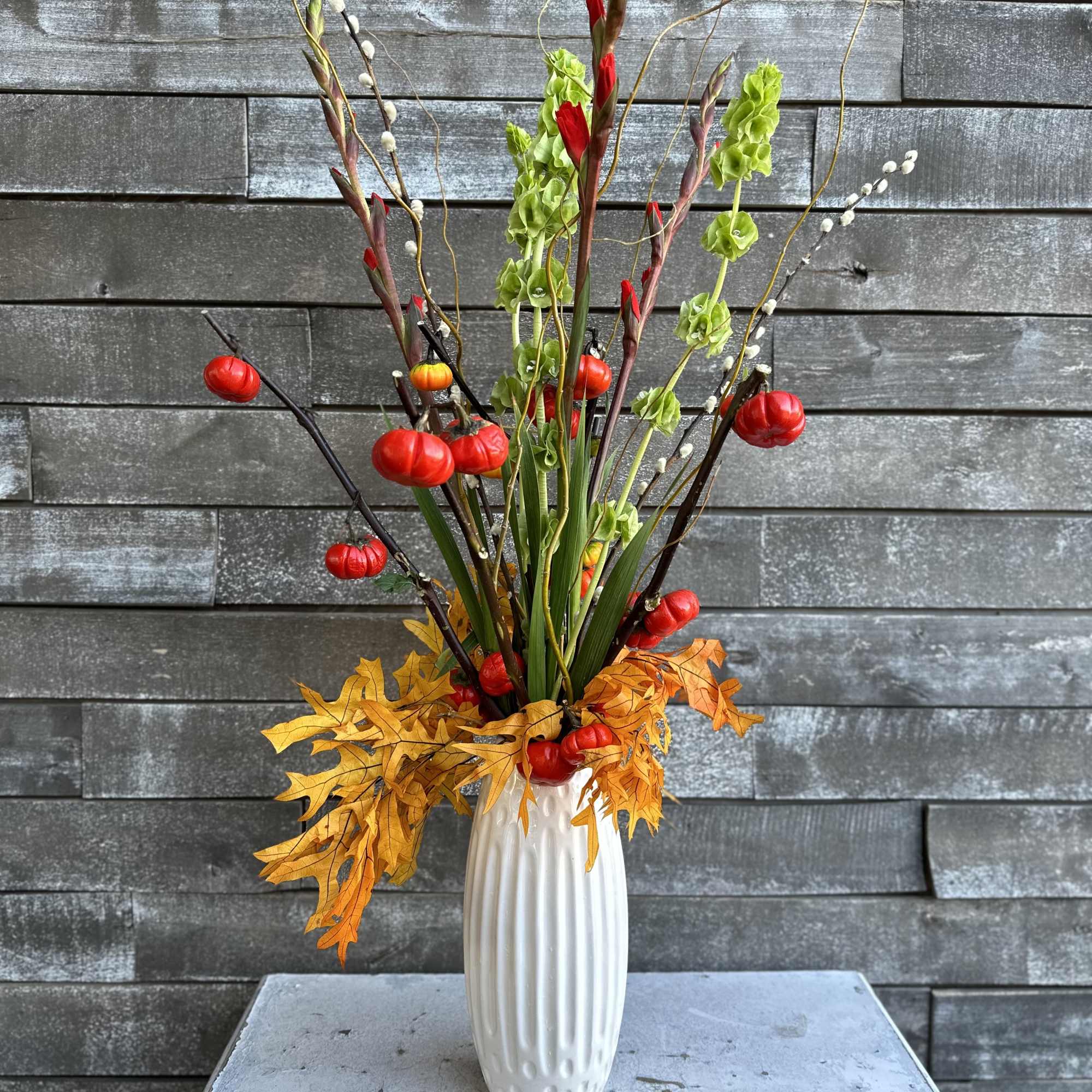 Mini pumpkins with red gladiolus green bells of Ireland and touches of Mini pumpkins with red gladiolus green bells of Ireland and touches of