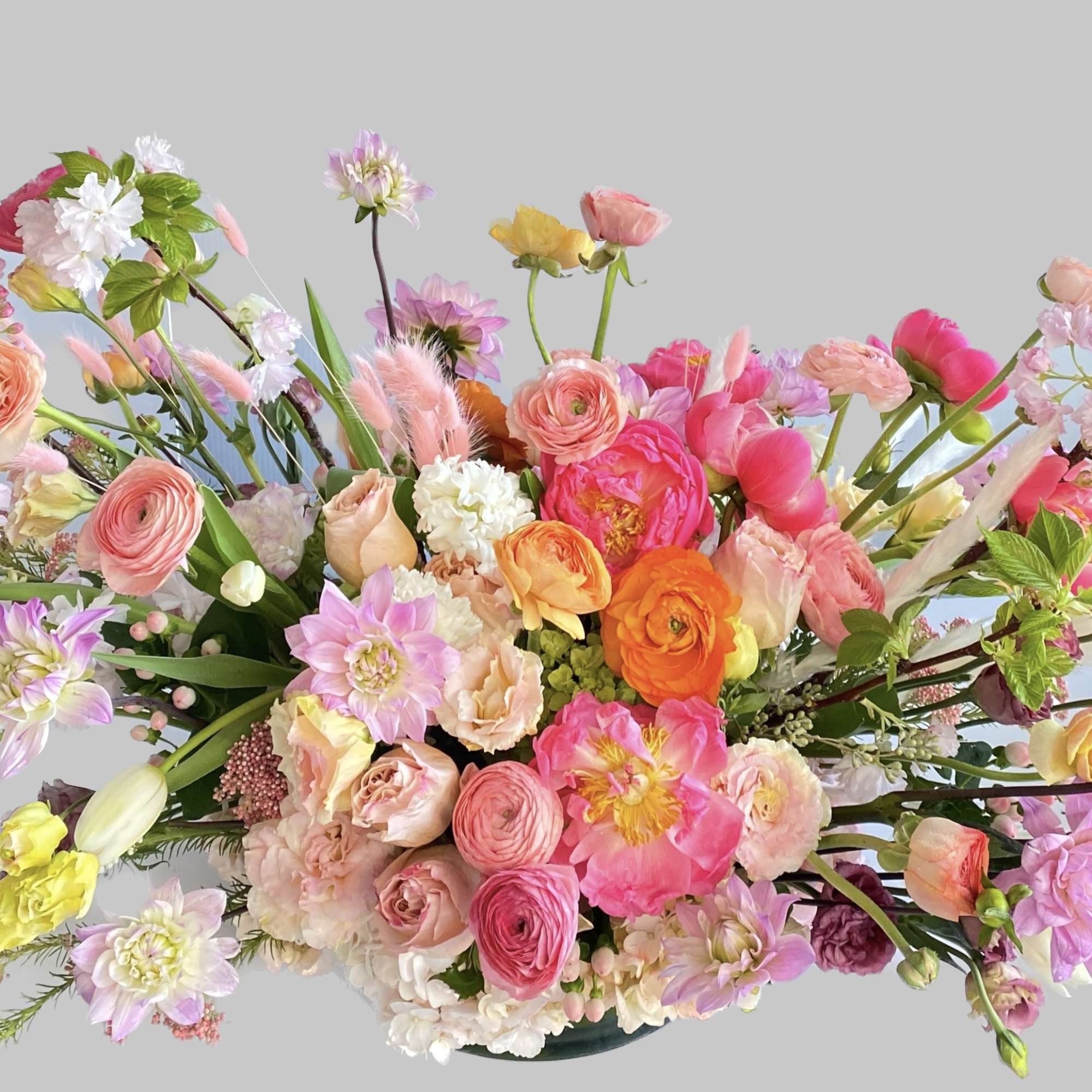 This arrangement is a gorgeous springy arrangement that has peach ranunculus, soft