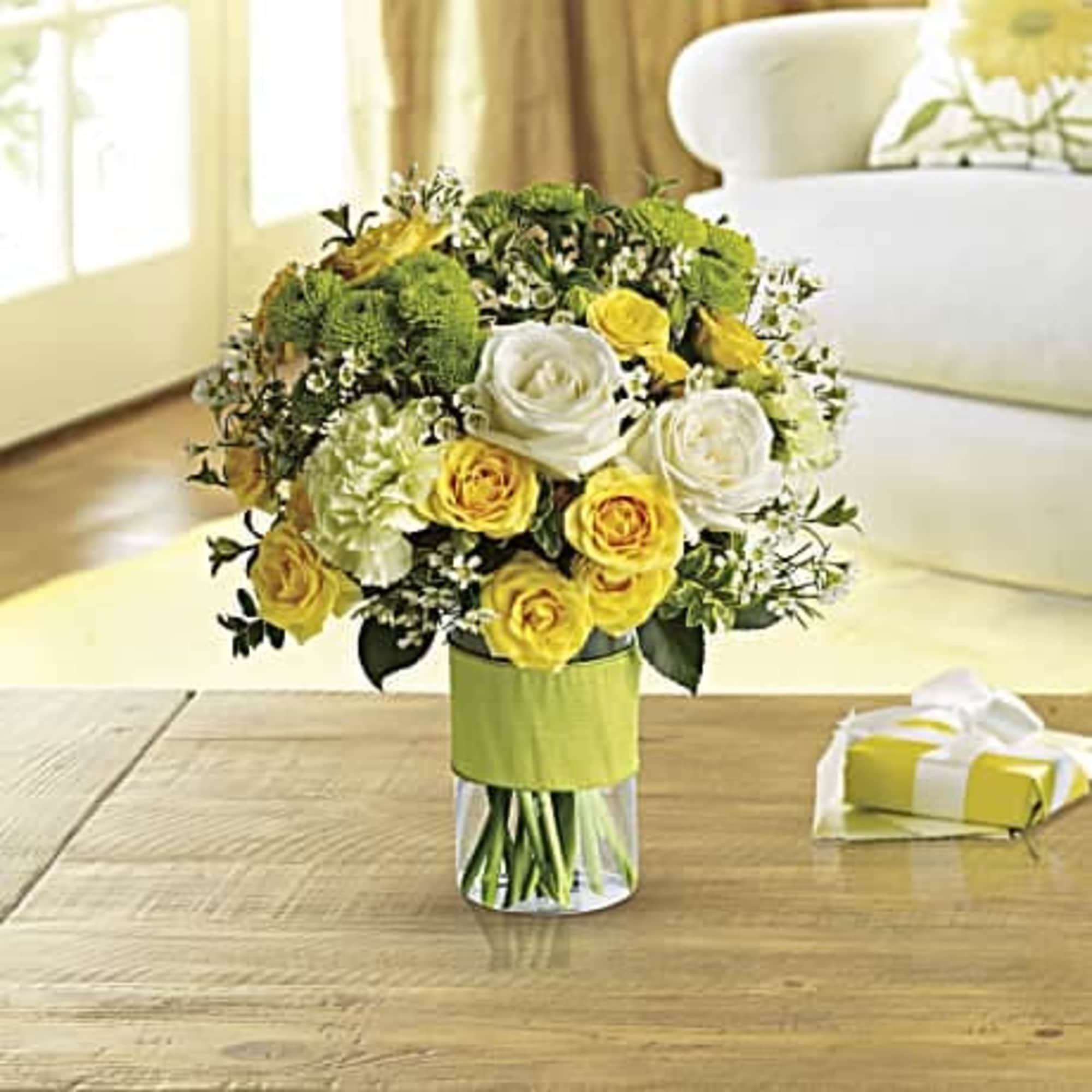 This beautiful  bouquet includes white roses, yellow spray roses, green carnations