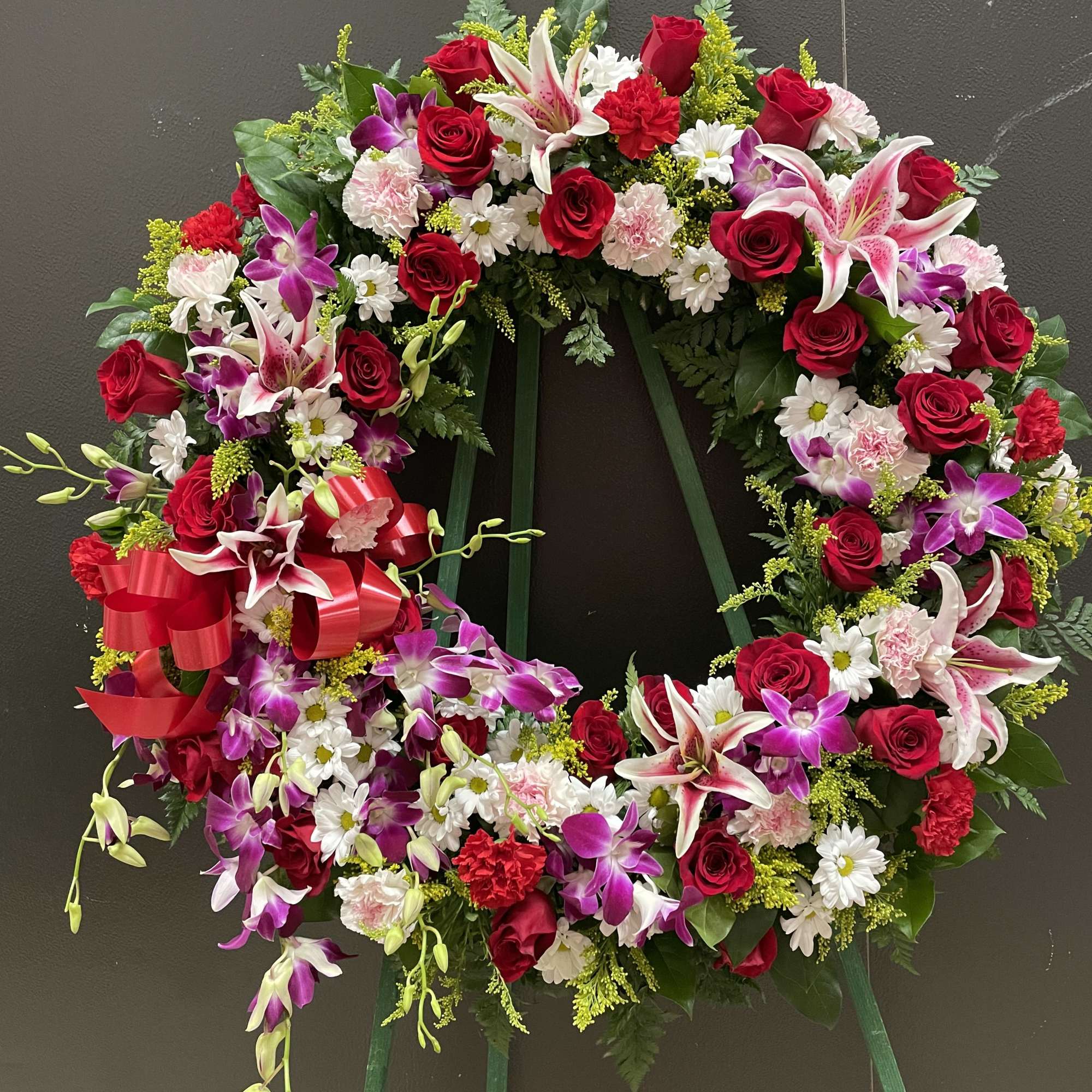 This Beautiful wreath made with dendrobium  orchid, red roses and pink