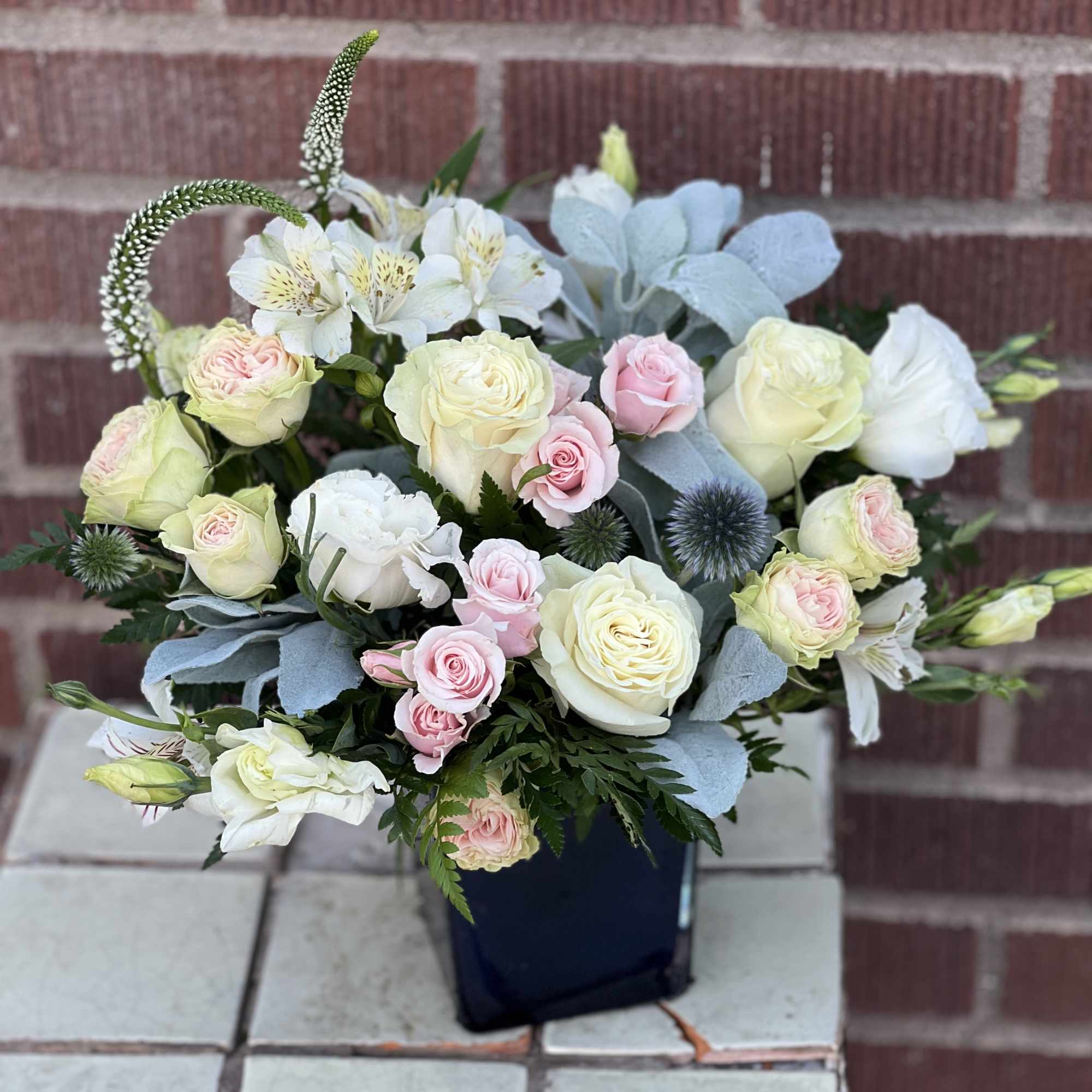 Add enchantment to their everyday with creamy roses and moody greens, artfully Add enchantment to their everyday with creamy roses and moody greens, artfully