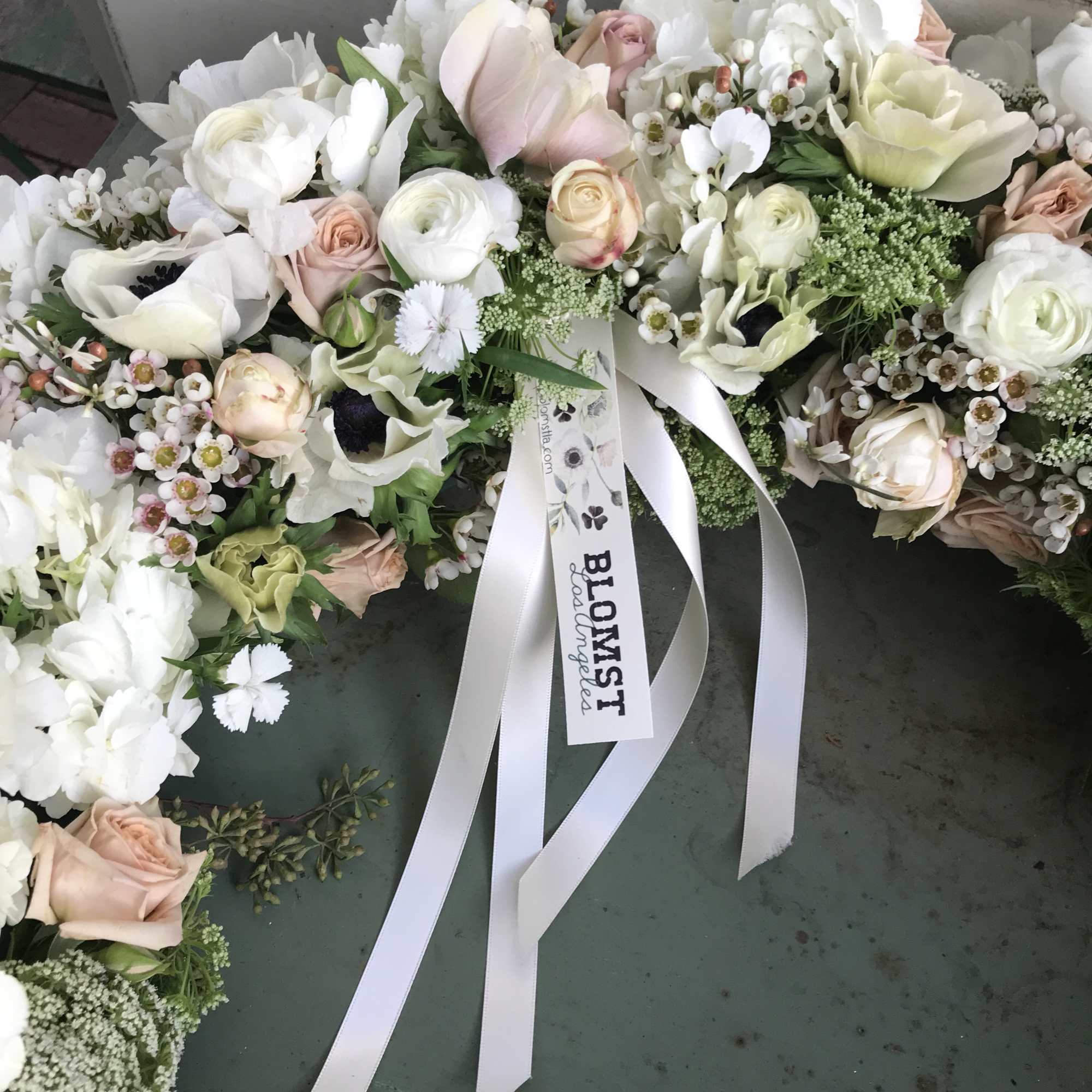 Beautiful wreath of fresh flowers in all white colors. Roses, anemones, ranunculus Beautiful wreath of fresh flowers in all white colors. Roses, anemones, ranunculus