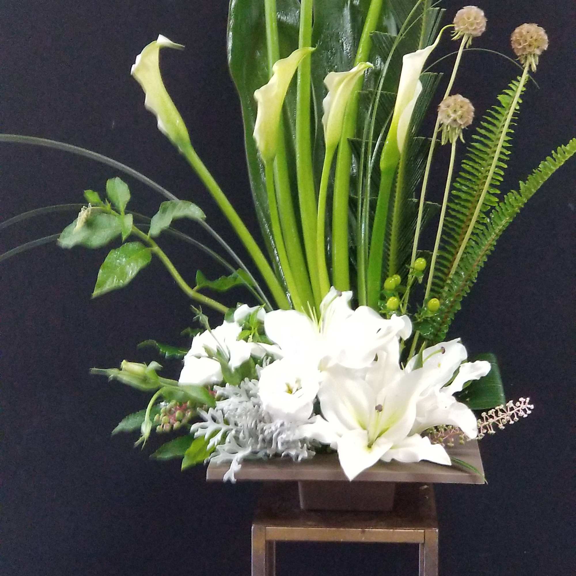 White flowers with Ikebana style of foliages and branches, concentrate on Line
