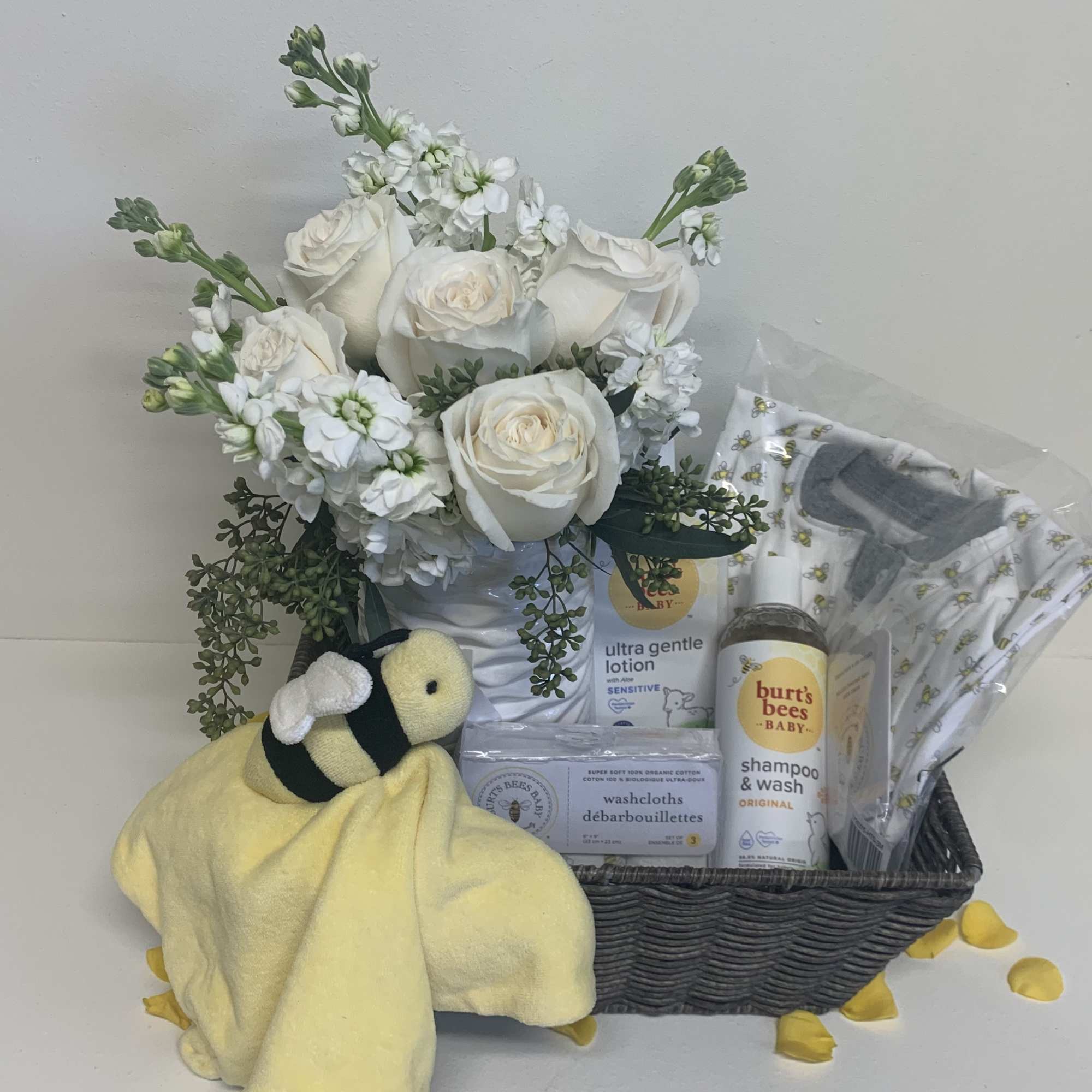 A simple wicker basket with a stunning white bouquet and filled with