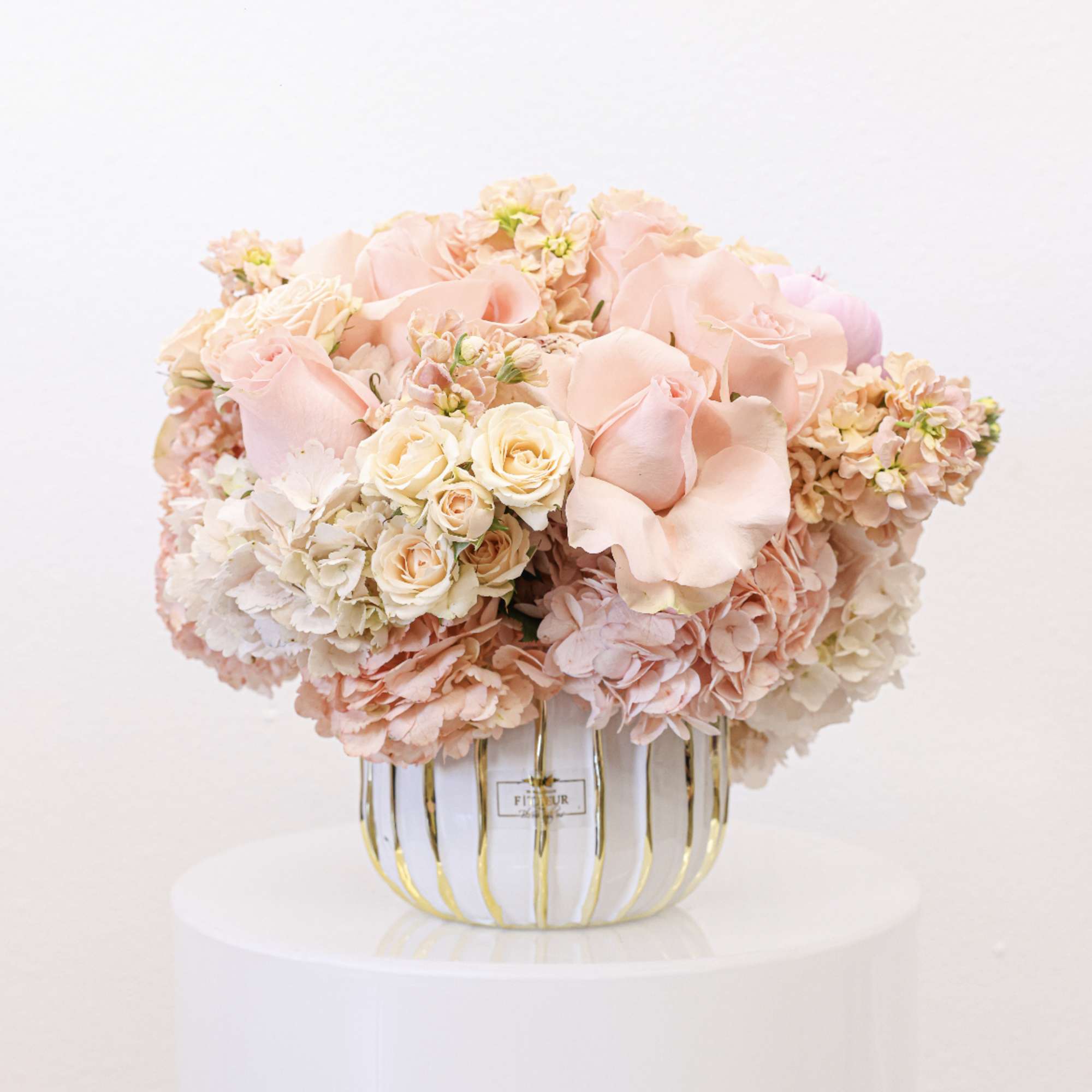 Bring beauty to the table with elegant arrangement, presented in a round