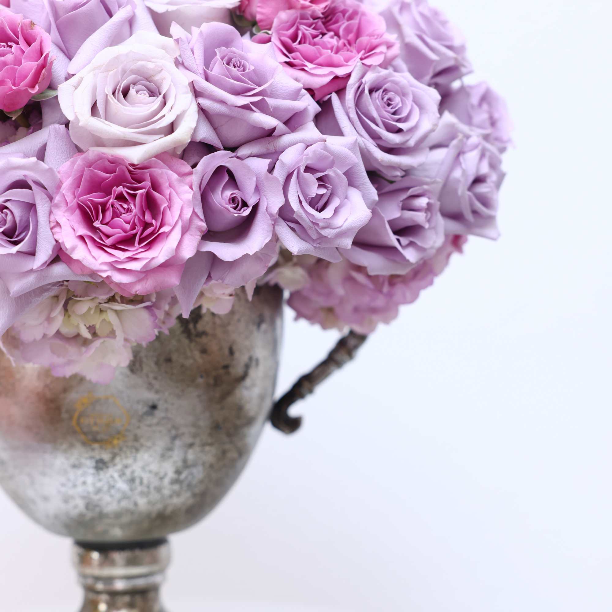 Bring beauty to the table with elegant arrangement, presented in a trophy