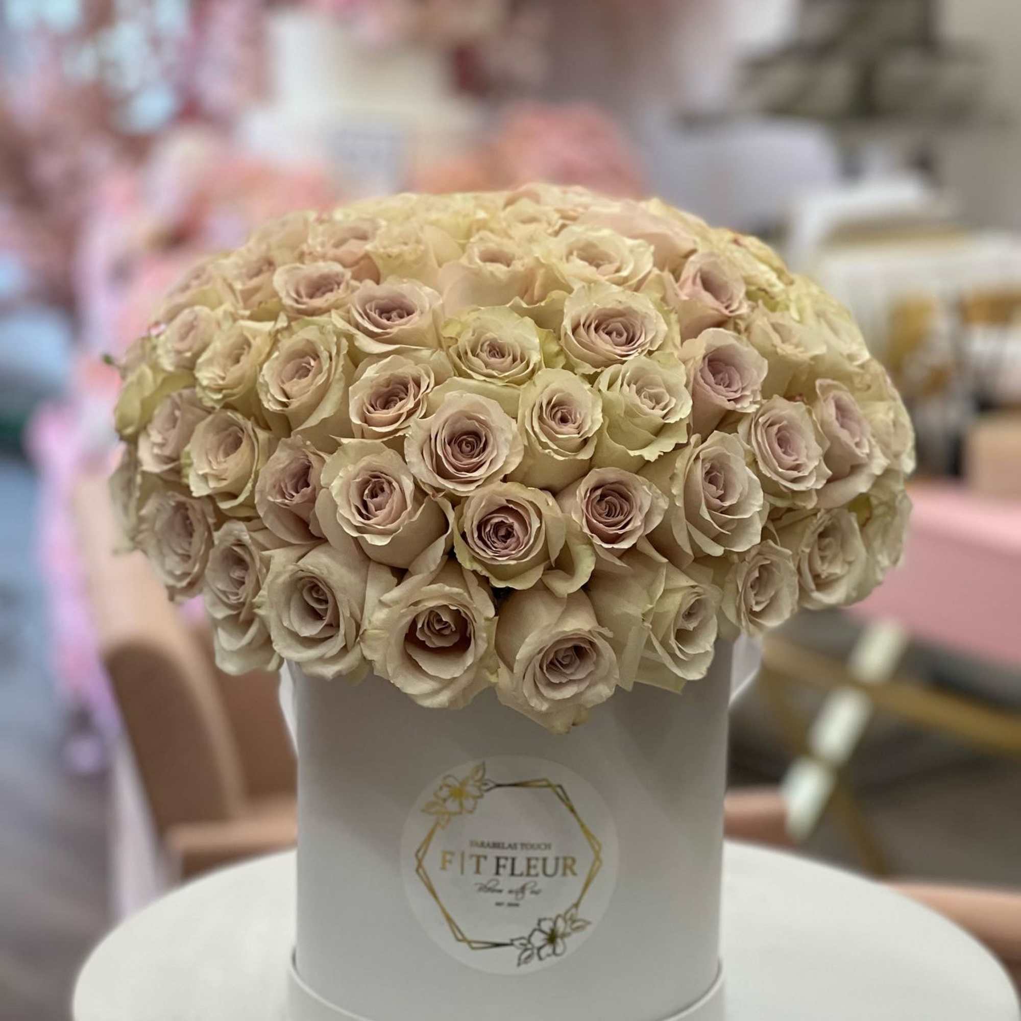 Bring beauty to the table with elegant arrangement, presented in a hat