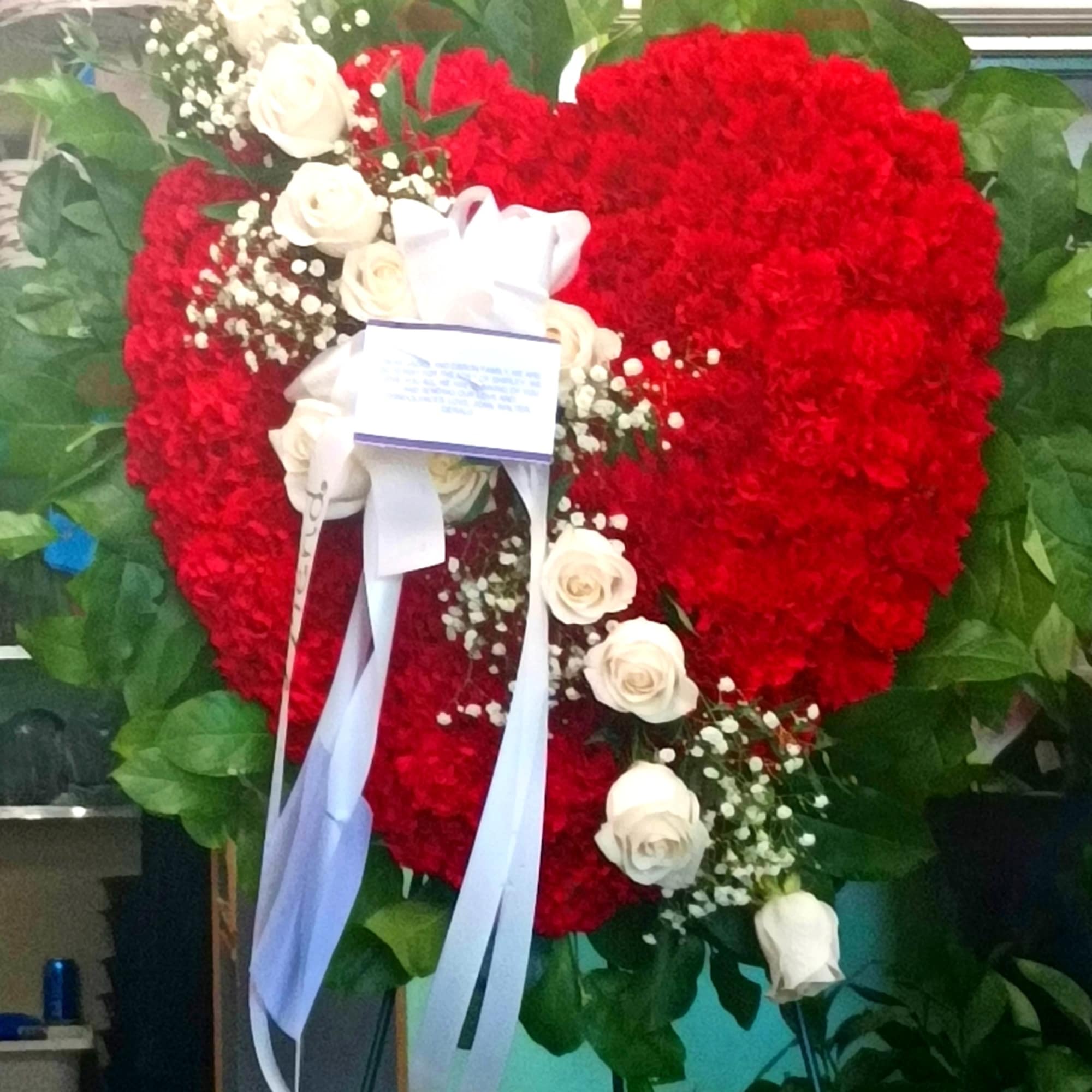 Honor a loved one with this standing heart-shaped arrangement that celebrates someone Honor a loved one with this standing heart-shaped arrangement that celebrates someone