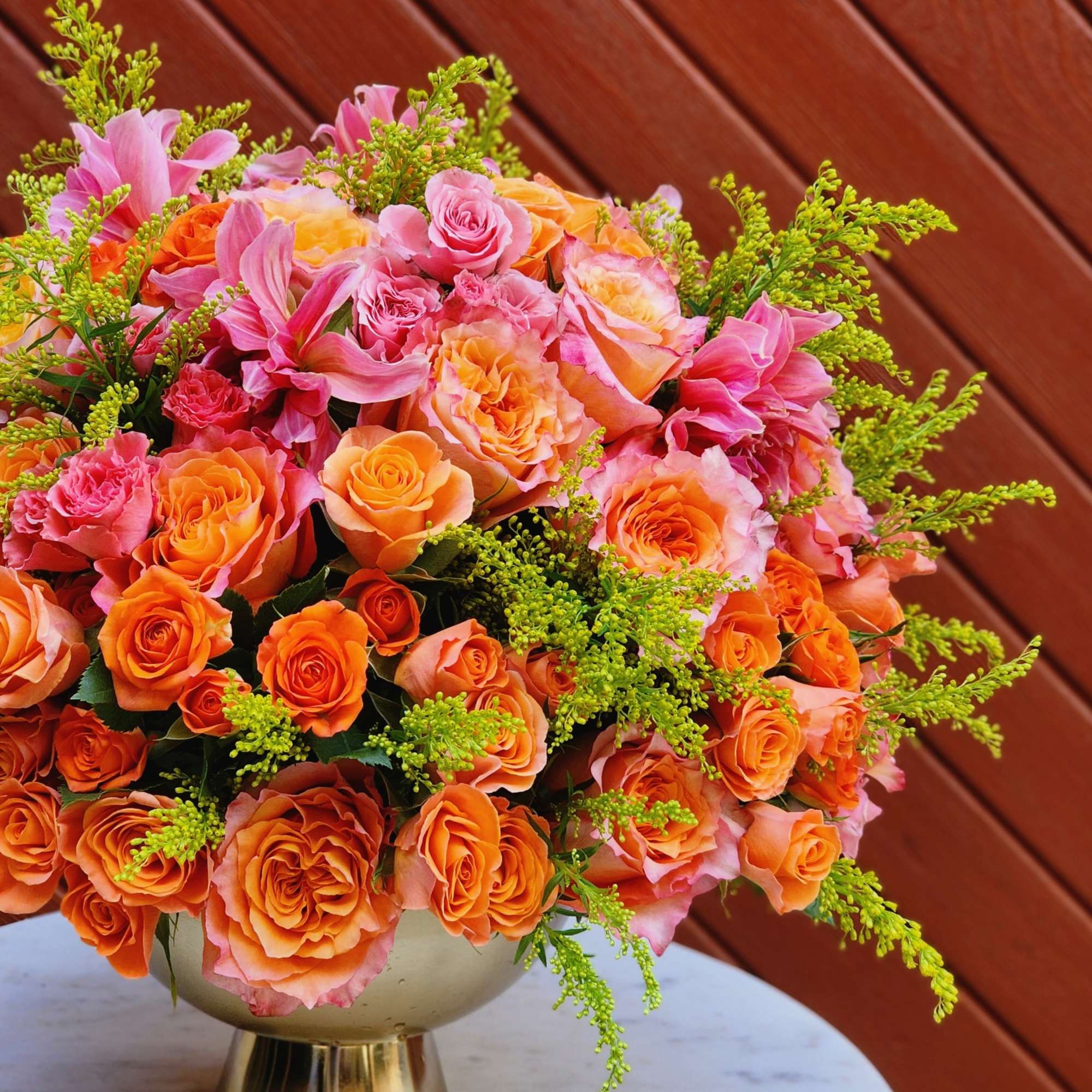 Bouquets and compositions of autumn flowers in a golden vase will decorate