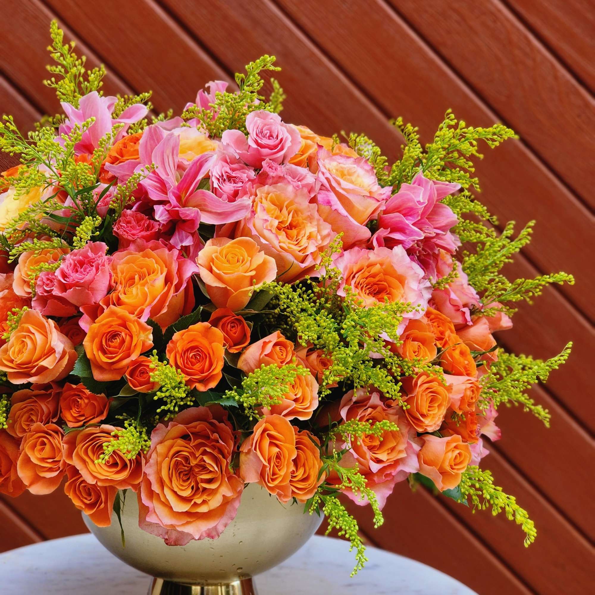 Bouquets and compositions of autumn flowers in a golden vase will decorate