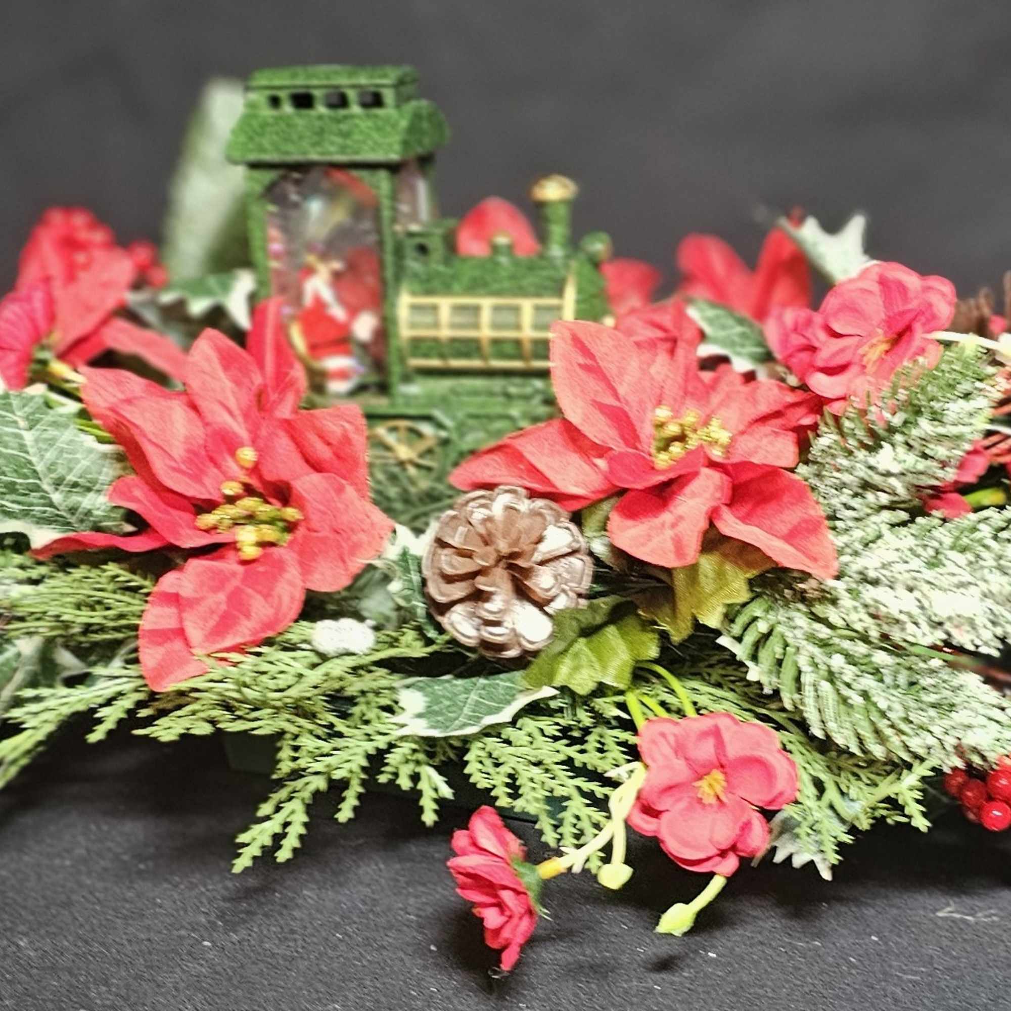 Lightup Santa train candle in classic poinsettia piece