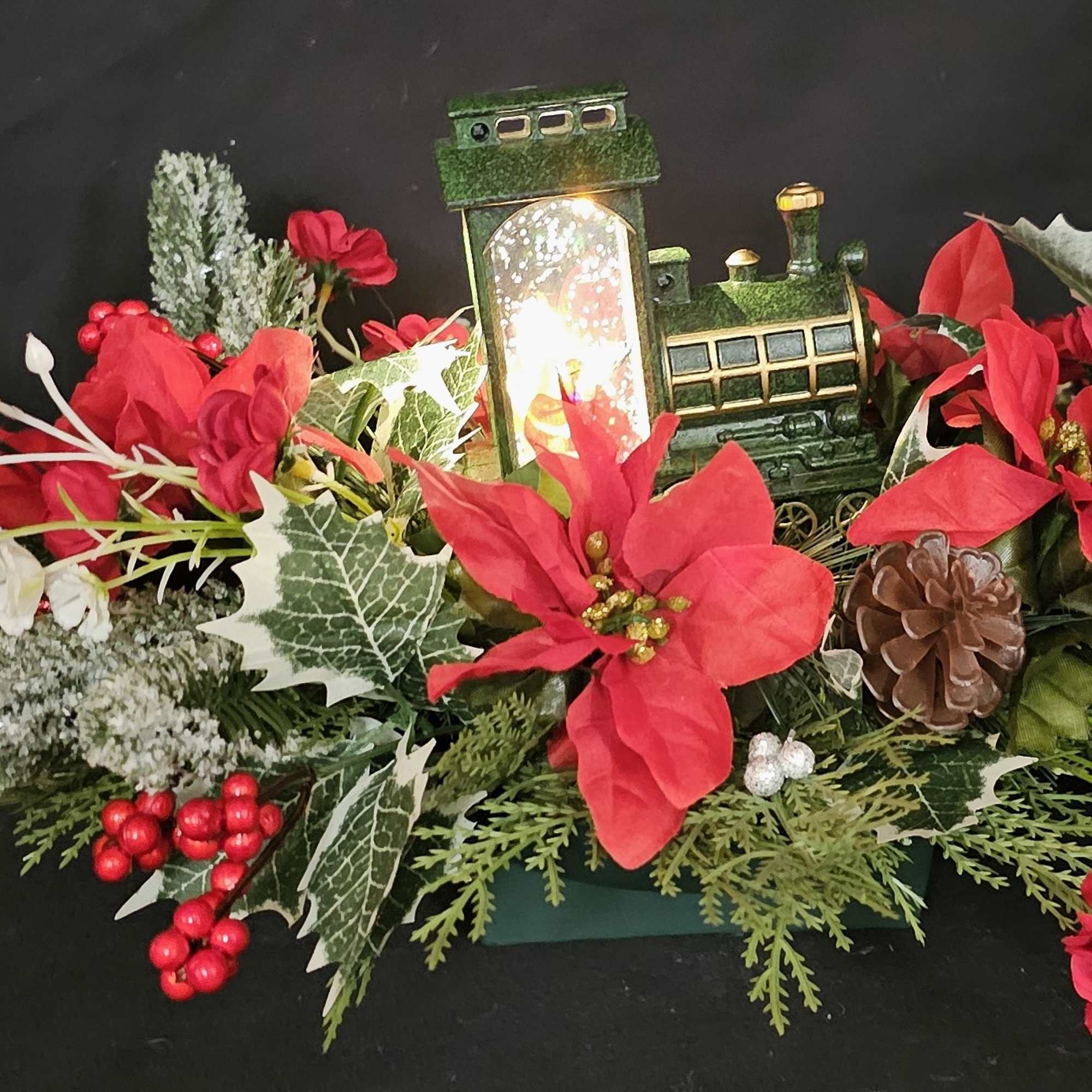 Lightup Santa train candle in classic poinsettia piece