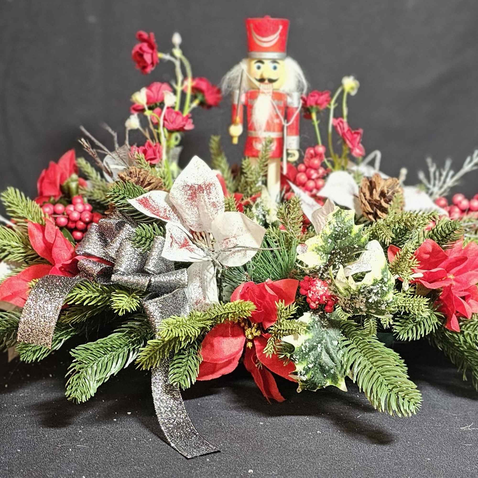 Classic nutcracker center with poinsettia leaves (artificial)