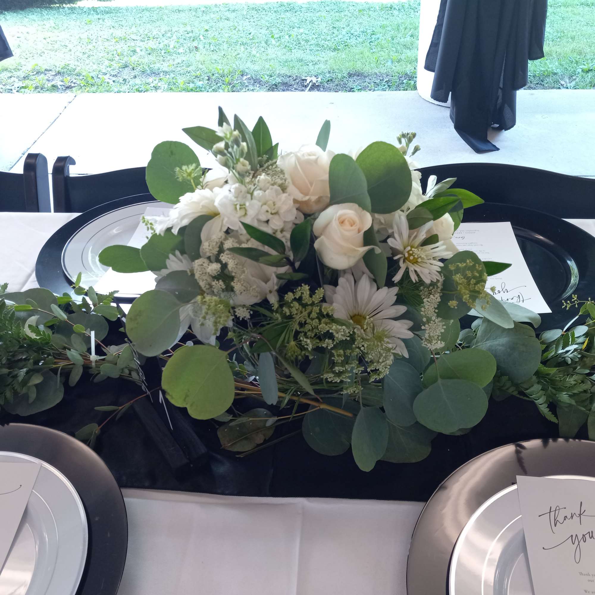 Beautiful white roses, hydrangea, alstroemeria, carnations and greens in a silver plastic