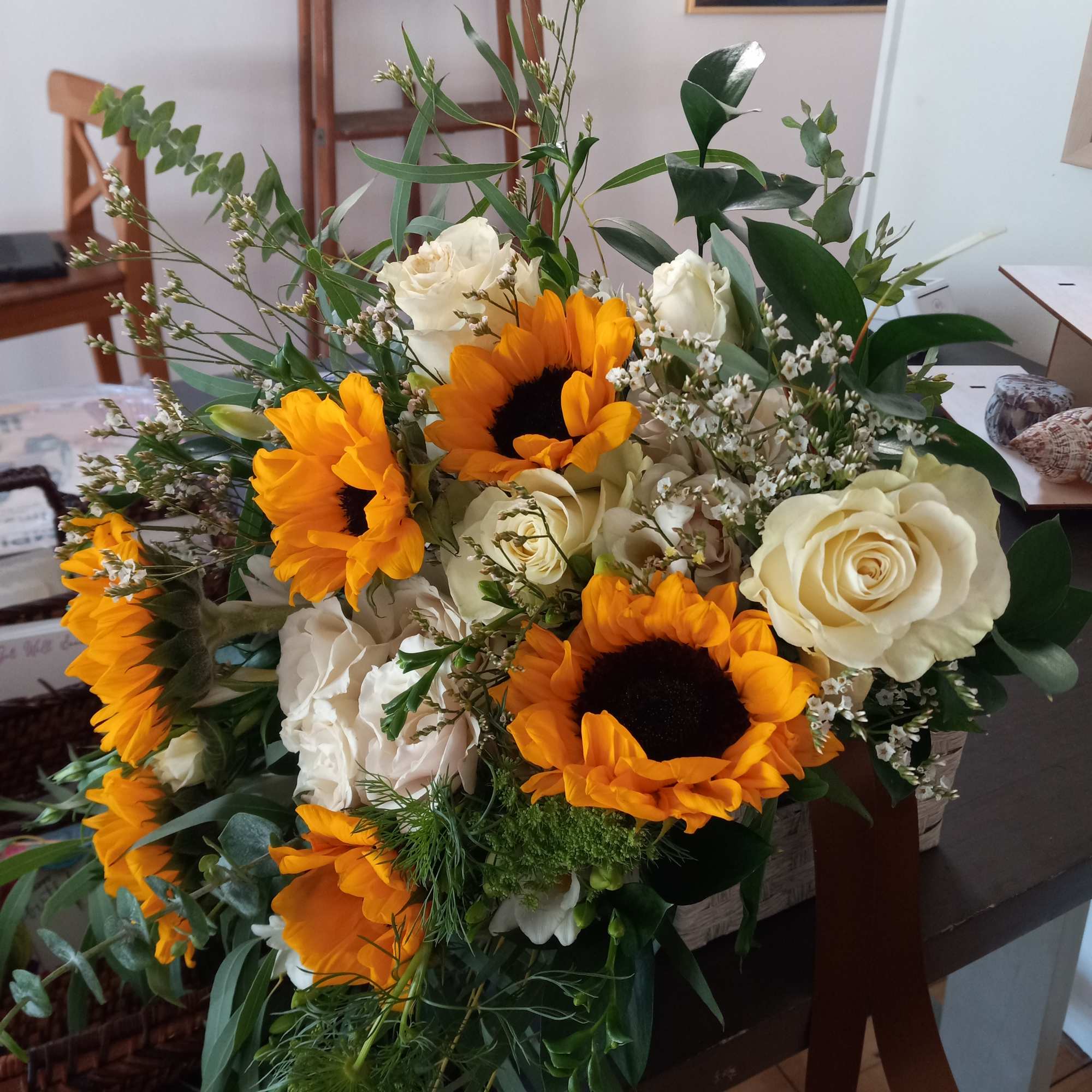 Stunning combination of large sunflowers and white rose in vintage hand tied