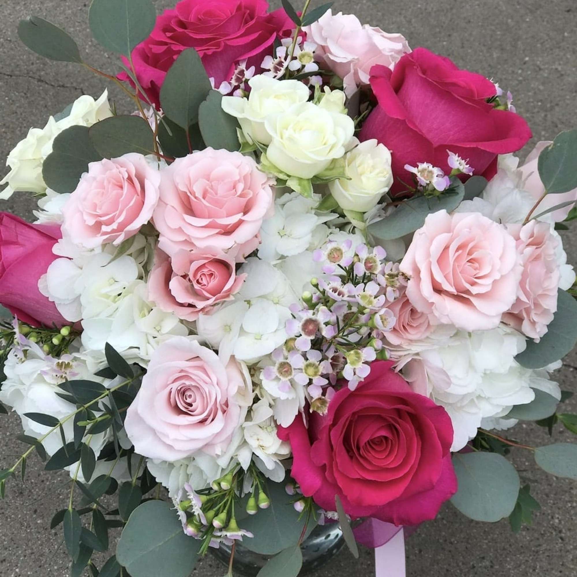 Hydrangeas, pink roses, pink spray roses, white spray roses, wax, and various