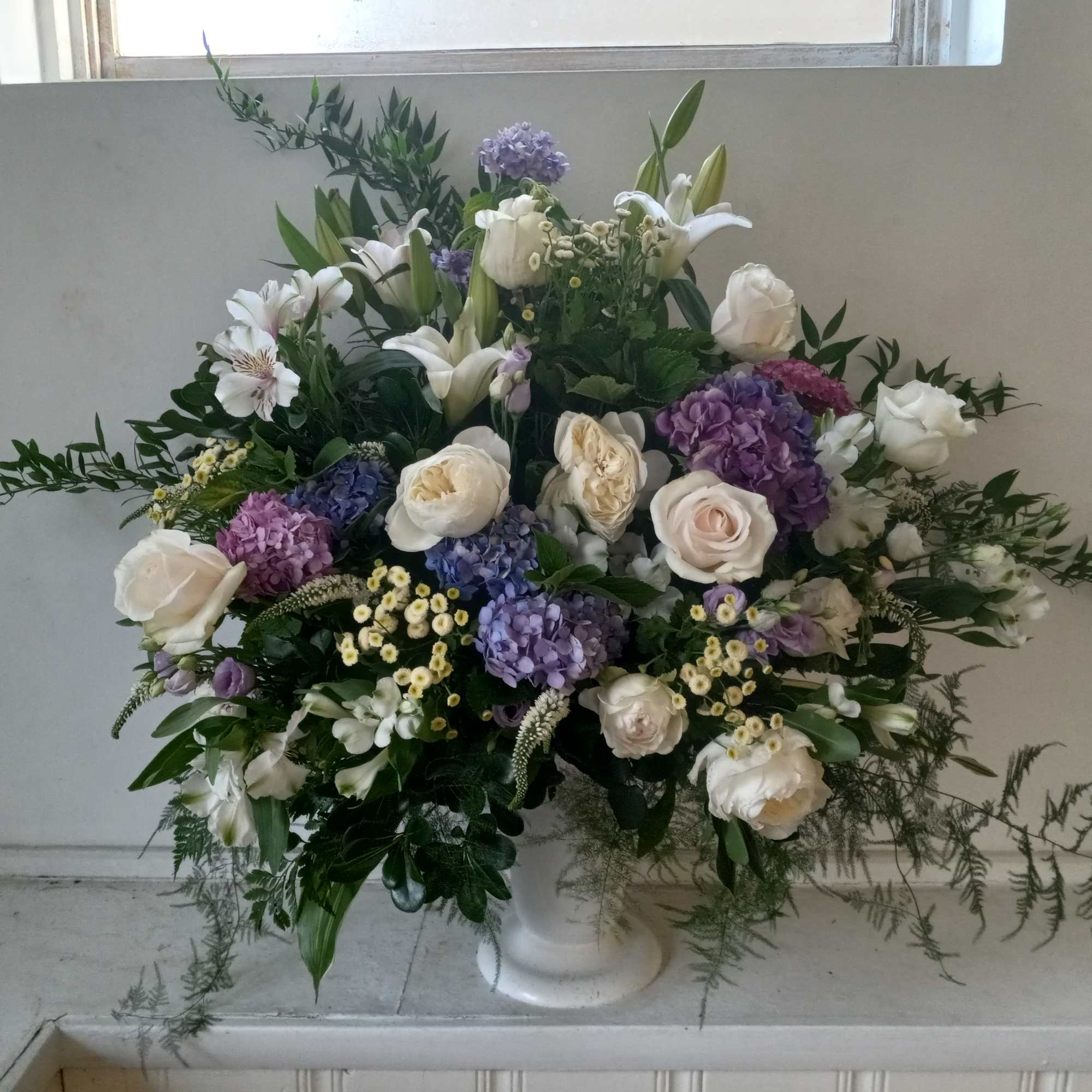 Beautiful purple &amp; white altar vase of white garden roses, lilies, alstroemeria