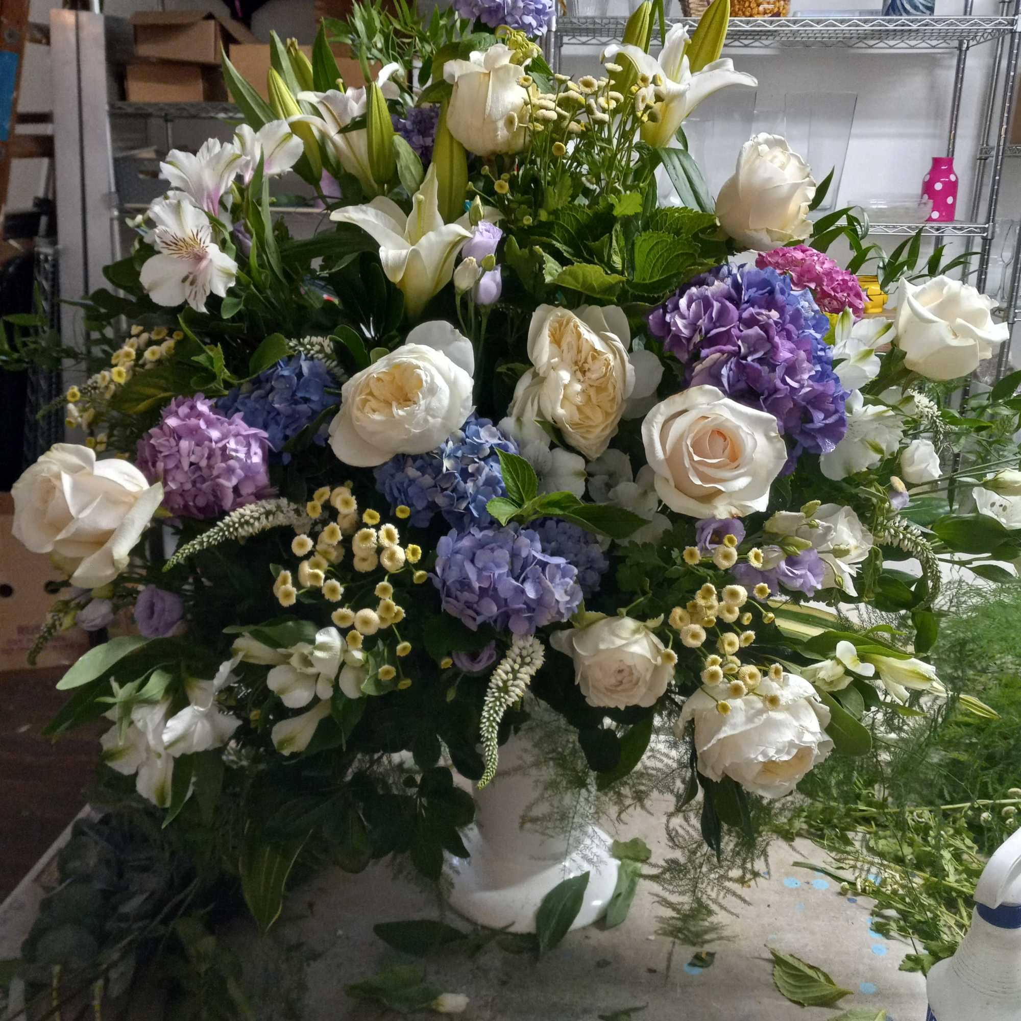 Beautiful purple &amp; white altar vase of white garden roses, lilies, alstroemeria