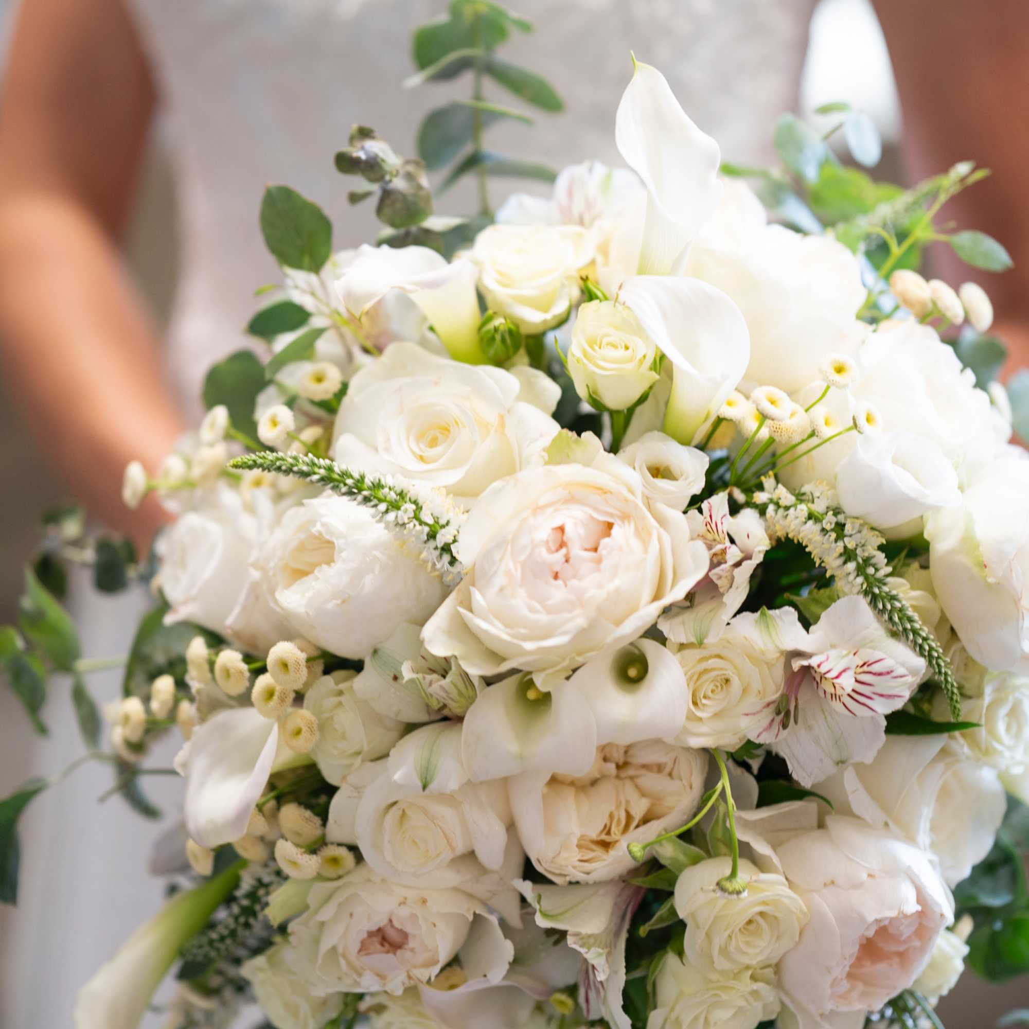 Beautiful white garden and spray roses, cala lilies, alstroemeria and other fillers