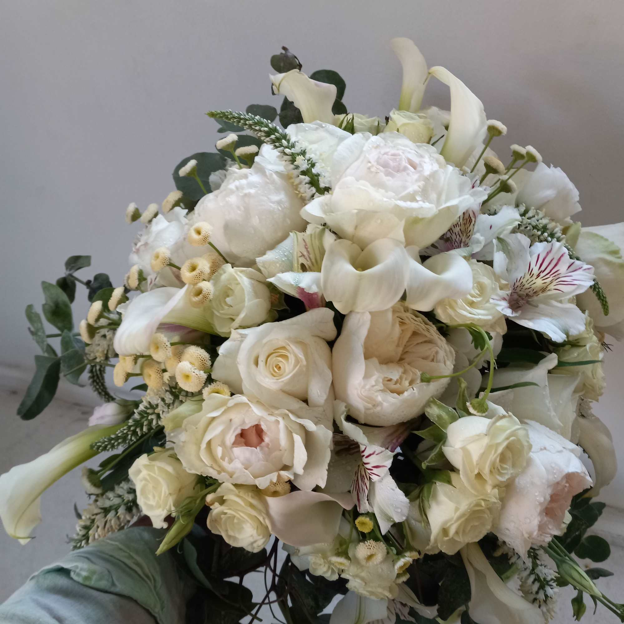 Beautiful white garden and spray roses, cala lilies, alstroemeria and other fillers