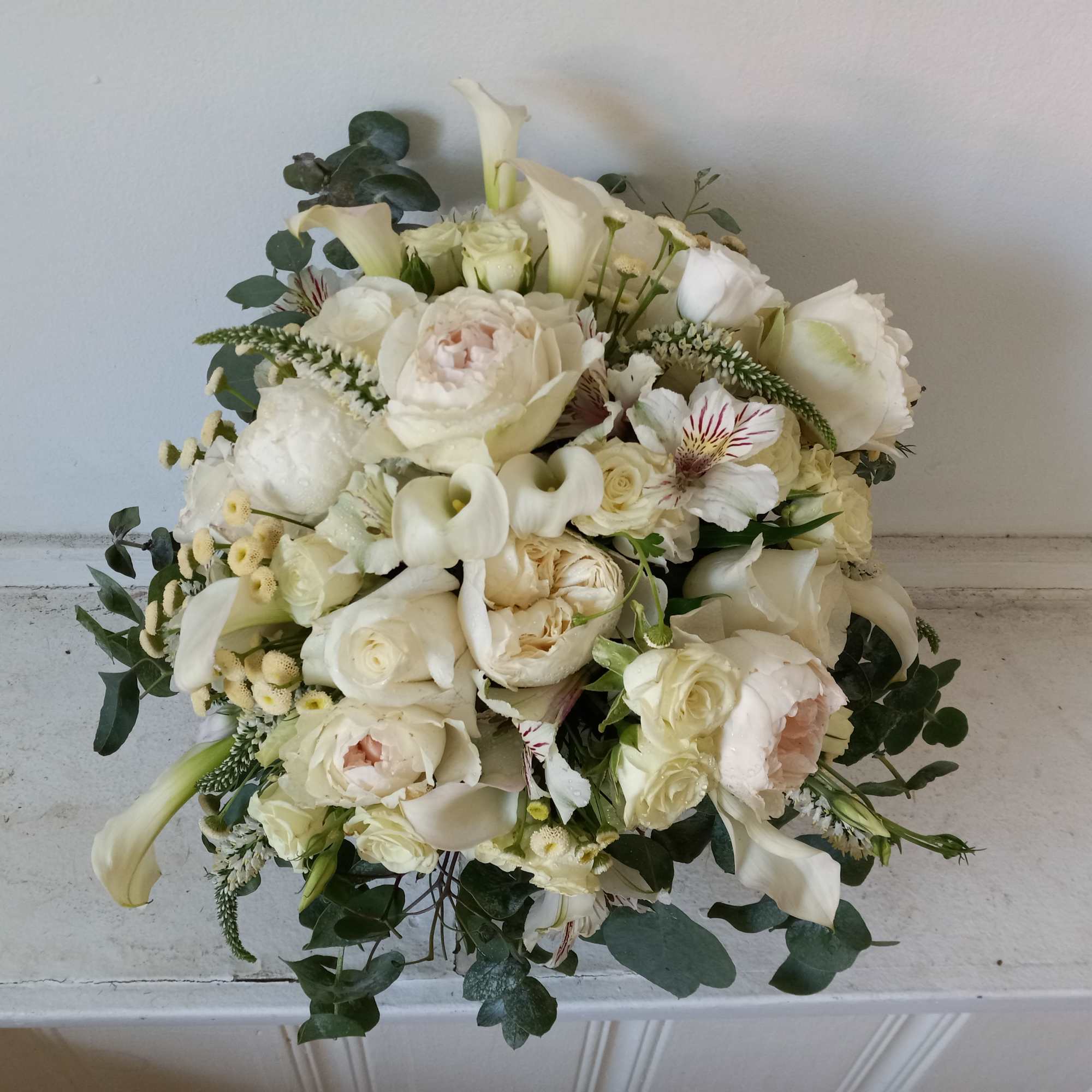 Beautiful white garden and spray roses, cala lilies, alstroemeria and other fillers
