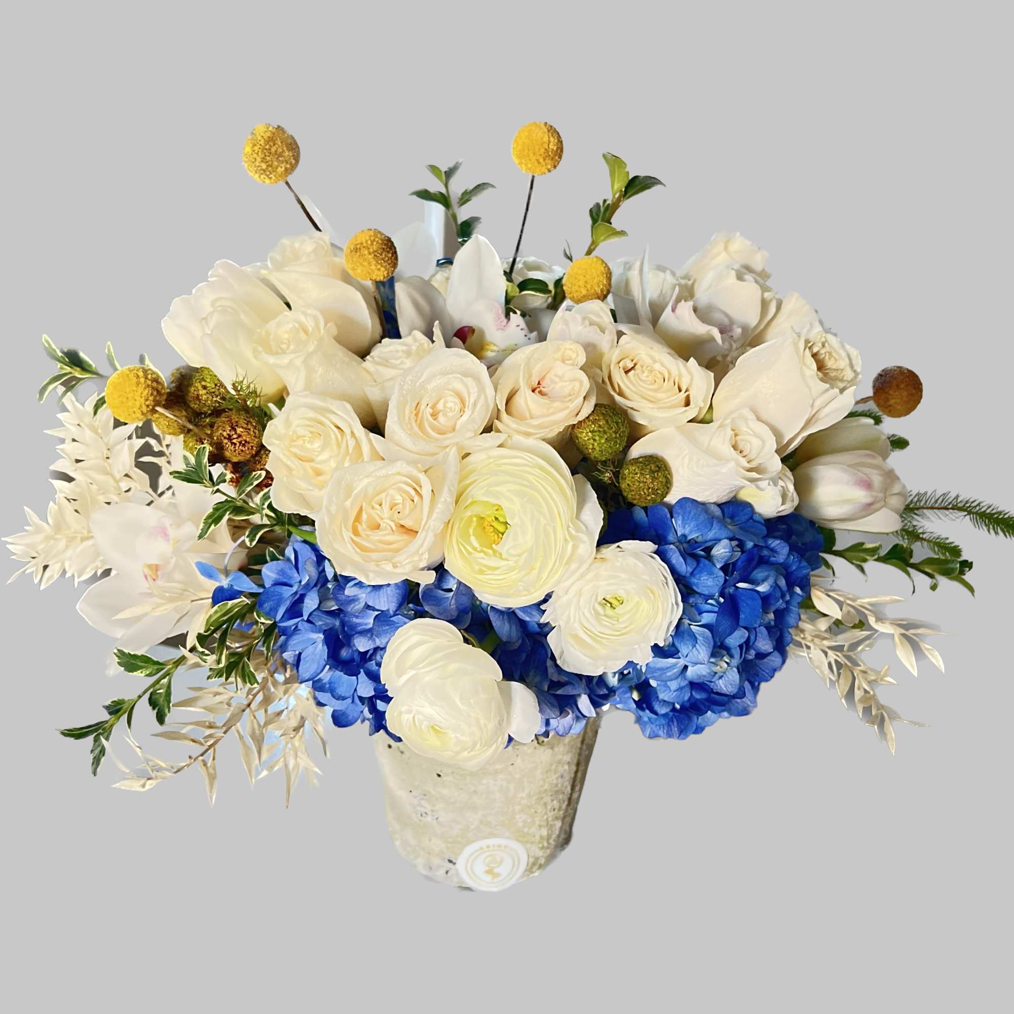 Classic and Beautiful, this arrangement whispers luxury. blue , yellow,whites and creams