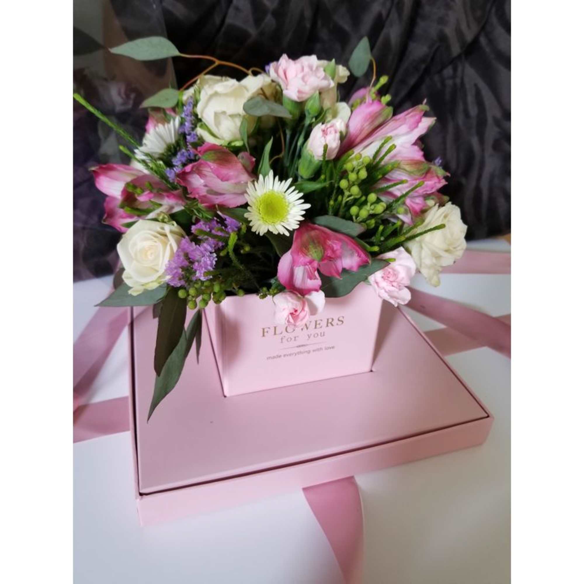 Box with clear sides. Arrangement includes spray roses, alstromeria, greenery and some Box with clear sides. Arrangement includes spray roses, alstromeria, greenery and some