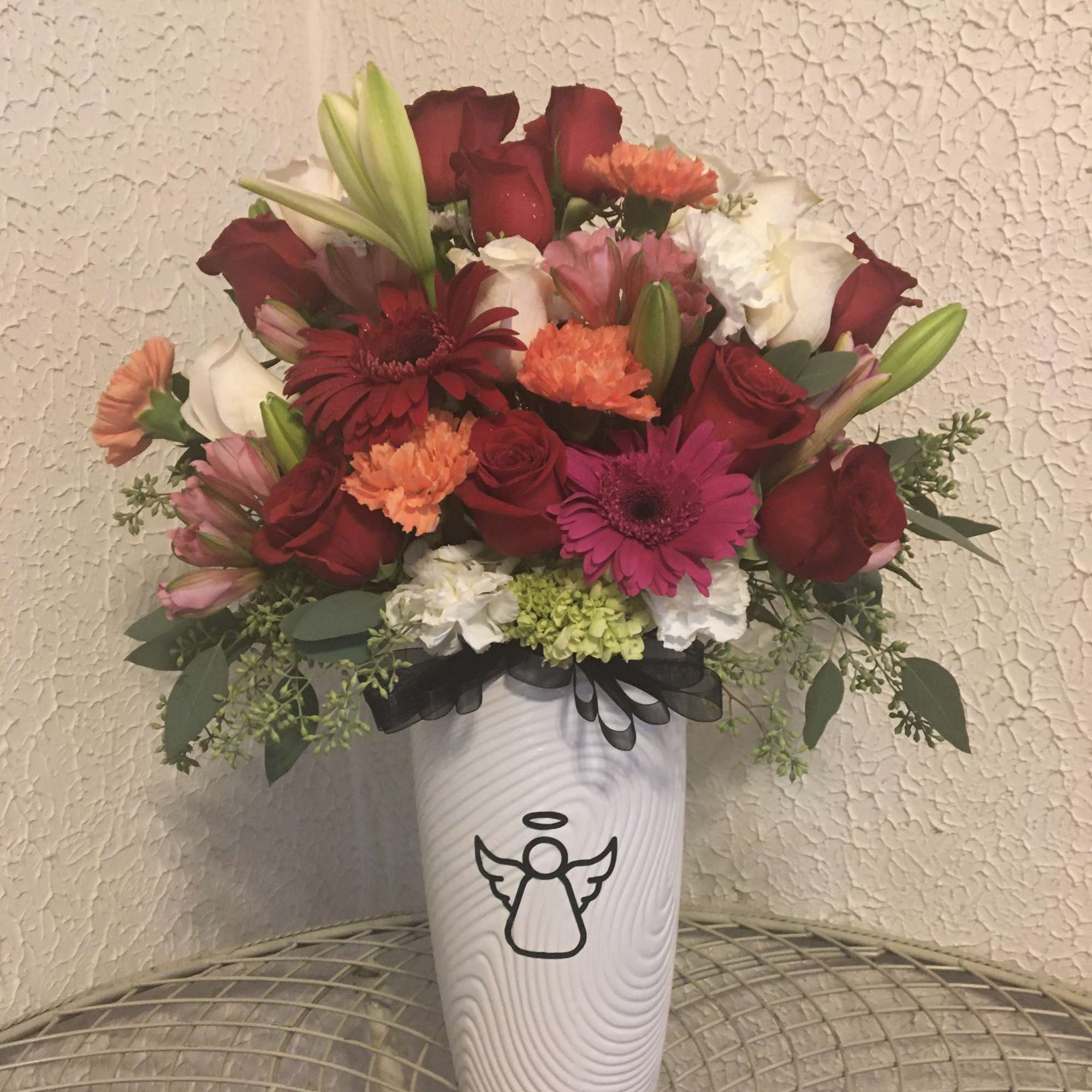 Beautiful arrangement in an angel vase