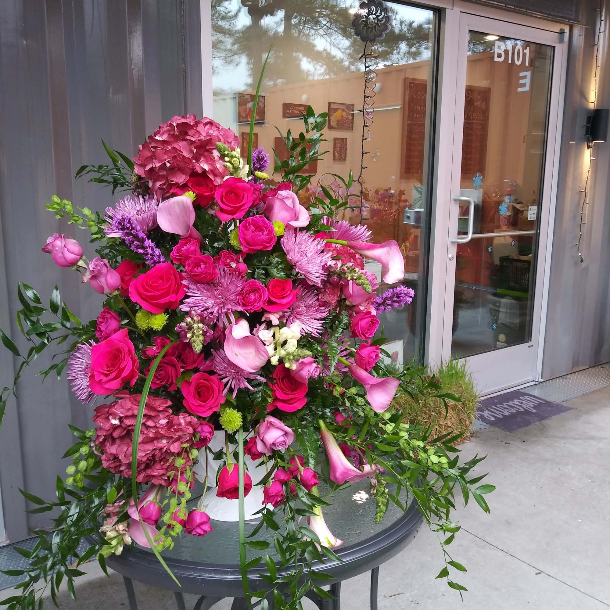 An exquisite one-sided display of hot pink Roses and spray roses, hydrangea An exquisite one-sided display of hot pink Roses and spray roses, hydrangea