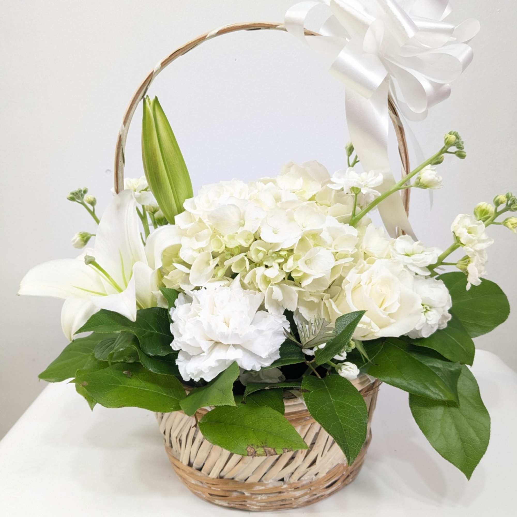 Send this all-white arrangement to the family&#039;s home to let them know