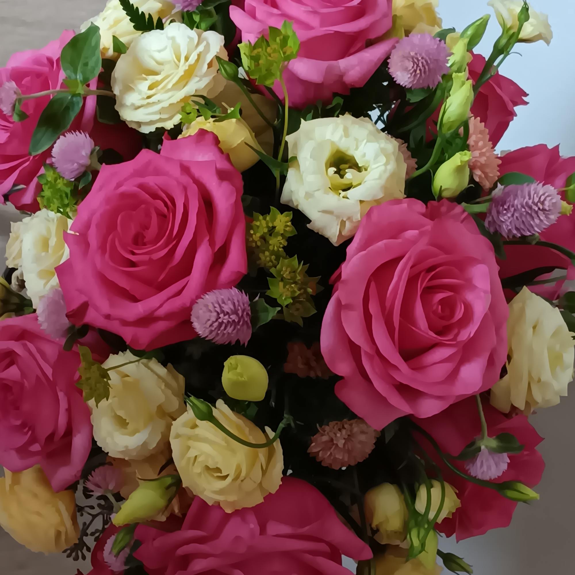 Blushing shades of pink blooms are nestled in lush greens to charm