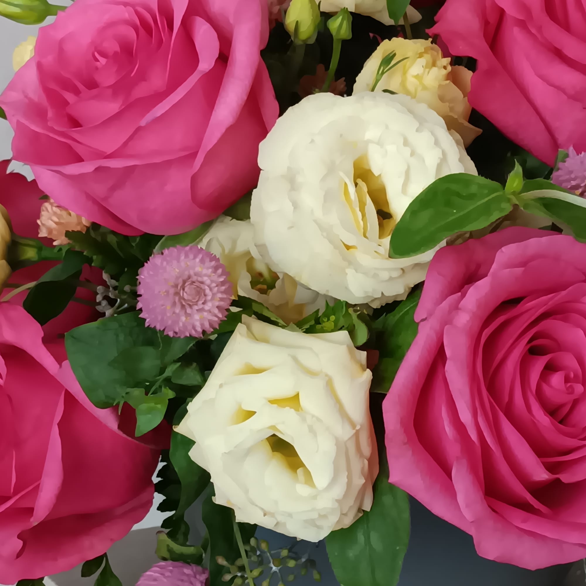 Blushing shades of pink blooms are nestled in lush greens to charm