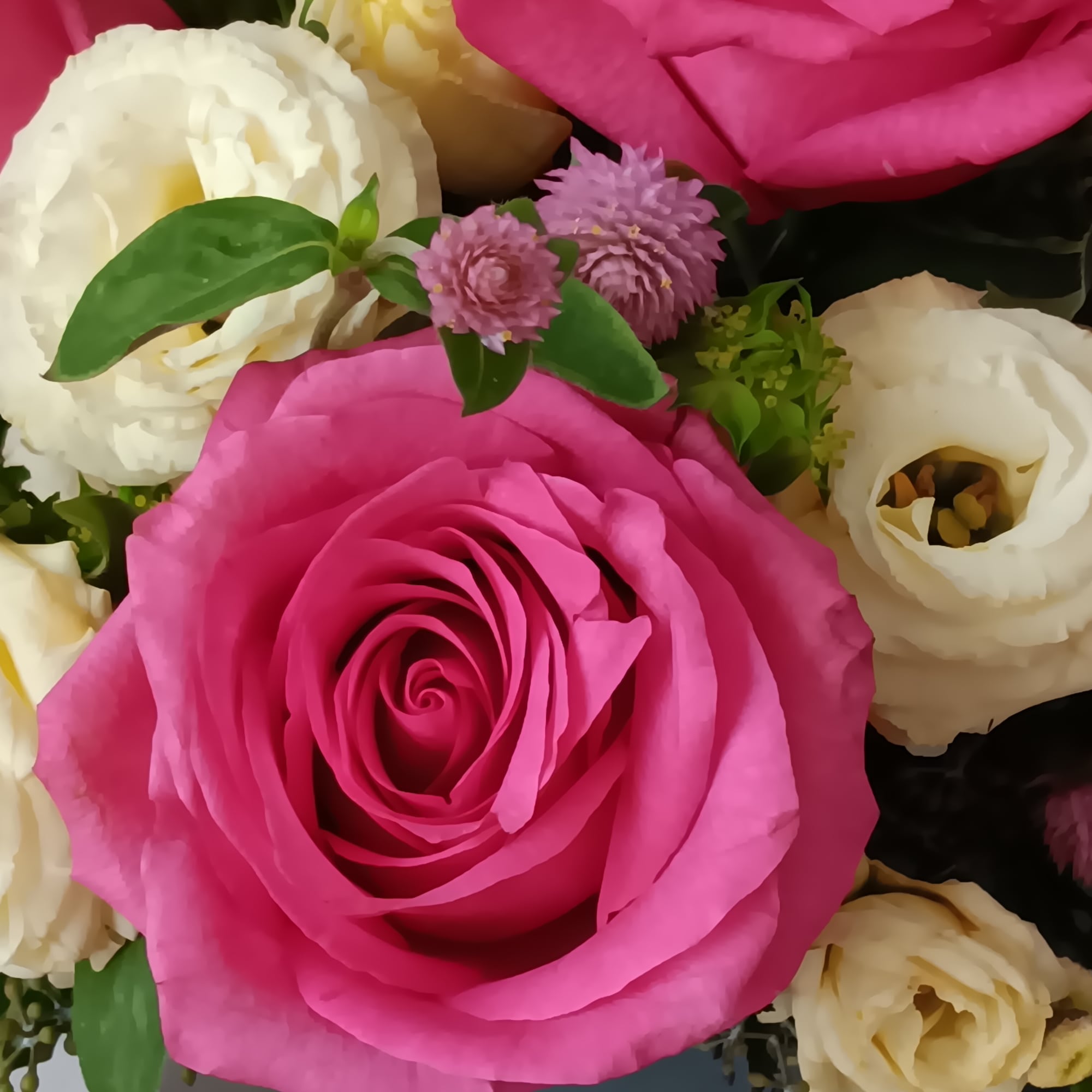 Blushing shades of pink blooms are nestled in lush greens to charm