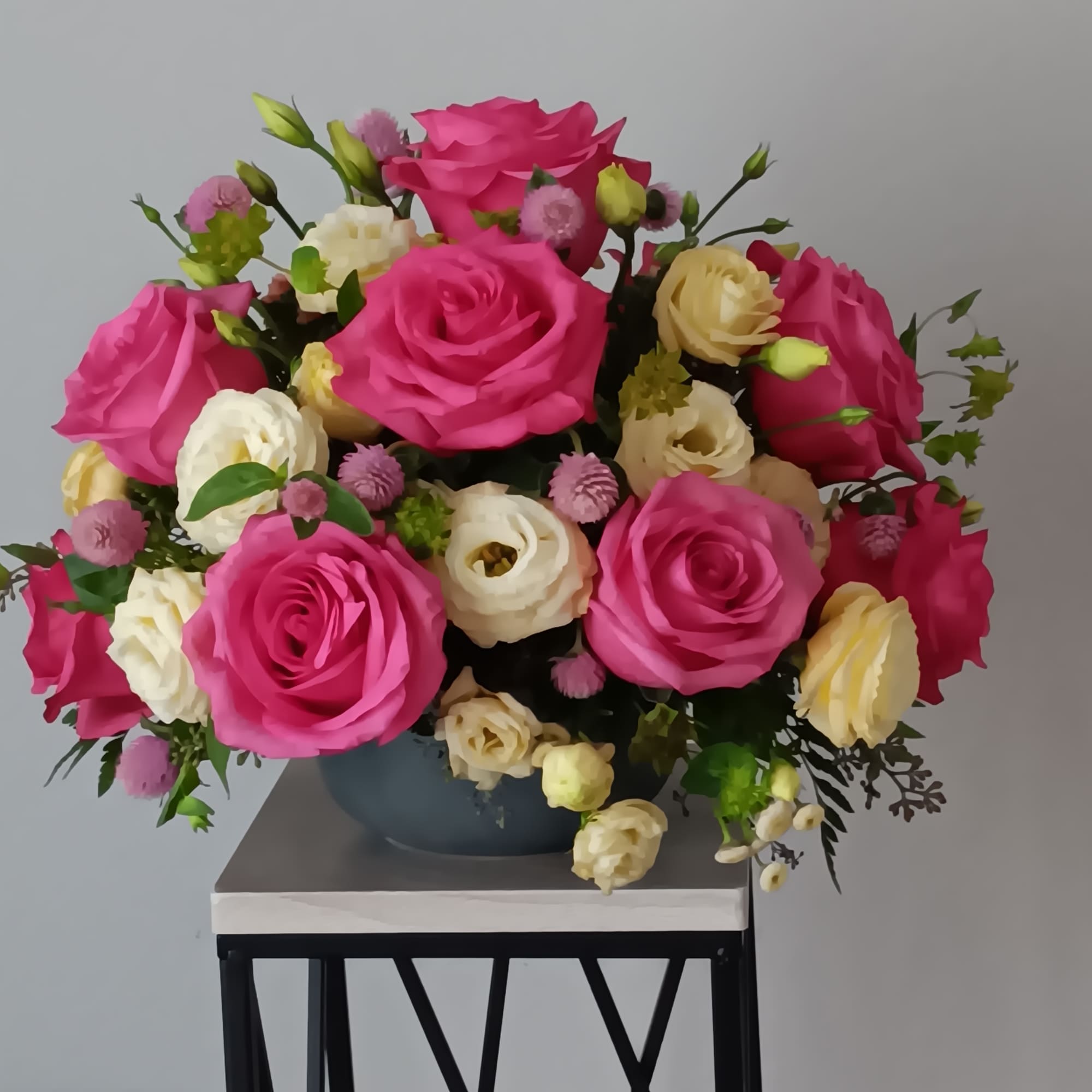 Blushing shades of pink blooms are nestled in lush greens to charm