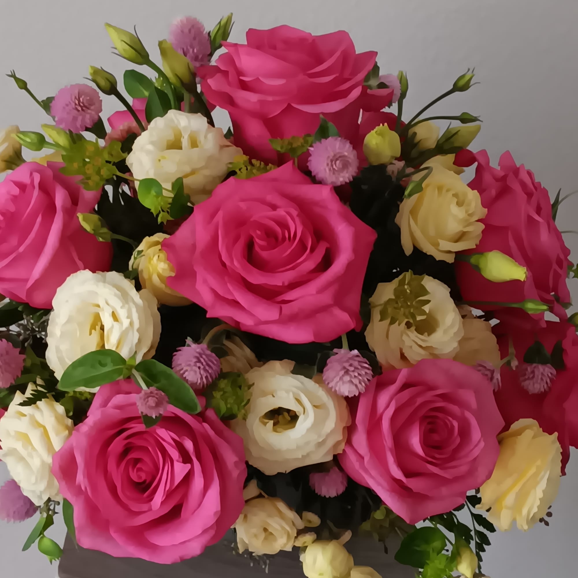 Blushing shades of pink blooms are nestled in lush greens to charm