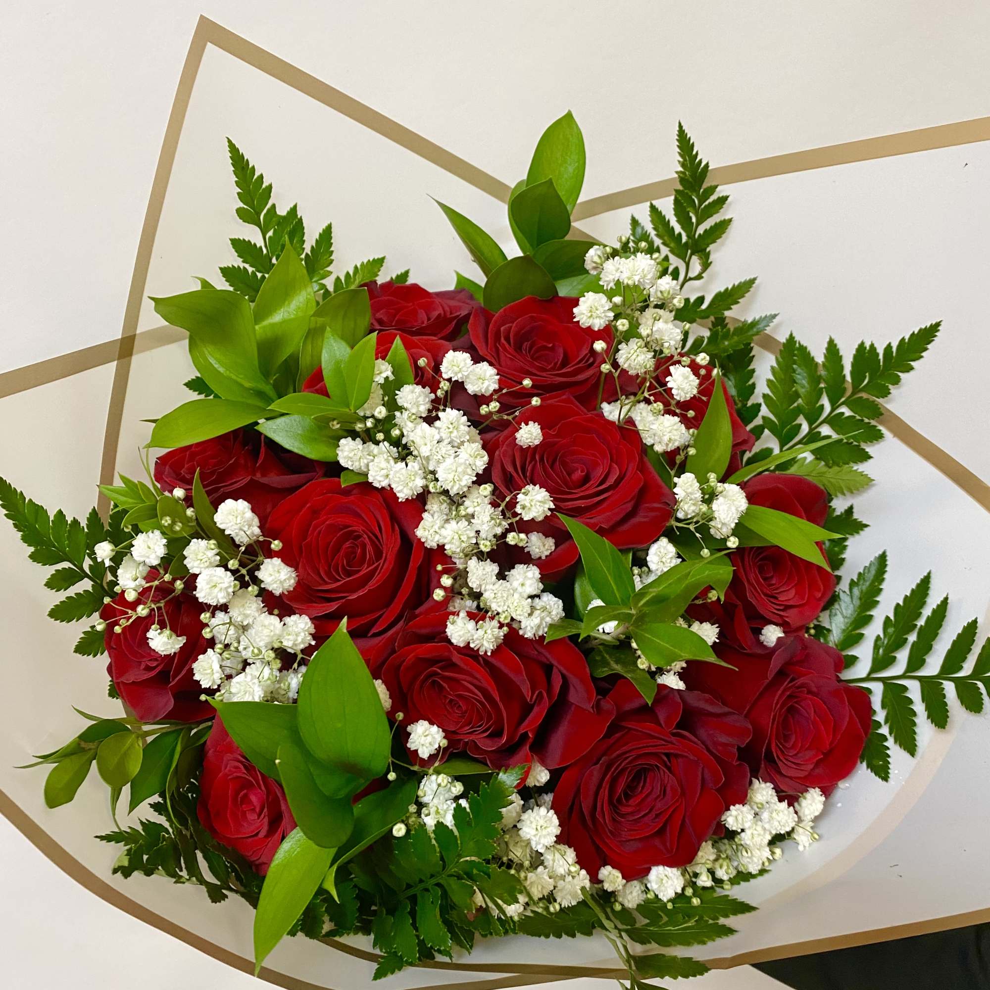 A Dozen Roses Wrapped with Babies Breath and Greenery. Vase Not Included

Write