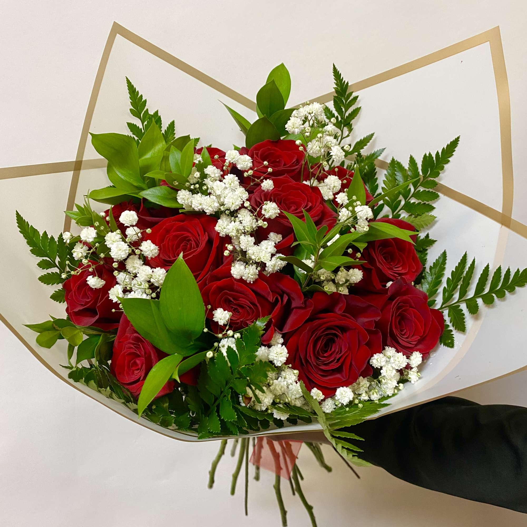 A Dozen Roses Wrapped with Babies Breath and Greenery. Vase Not Included

Write