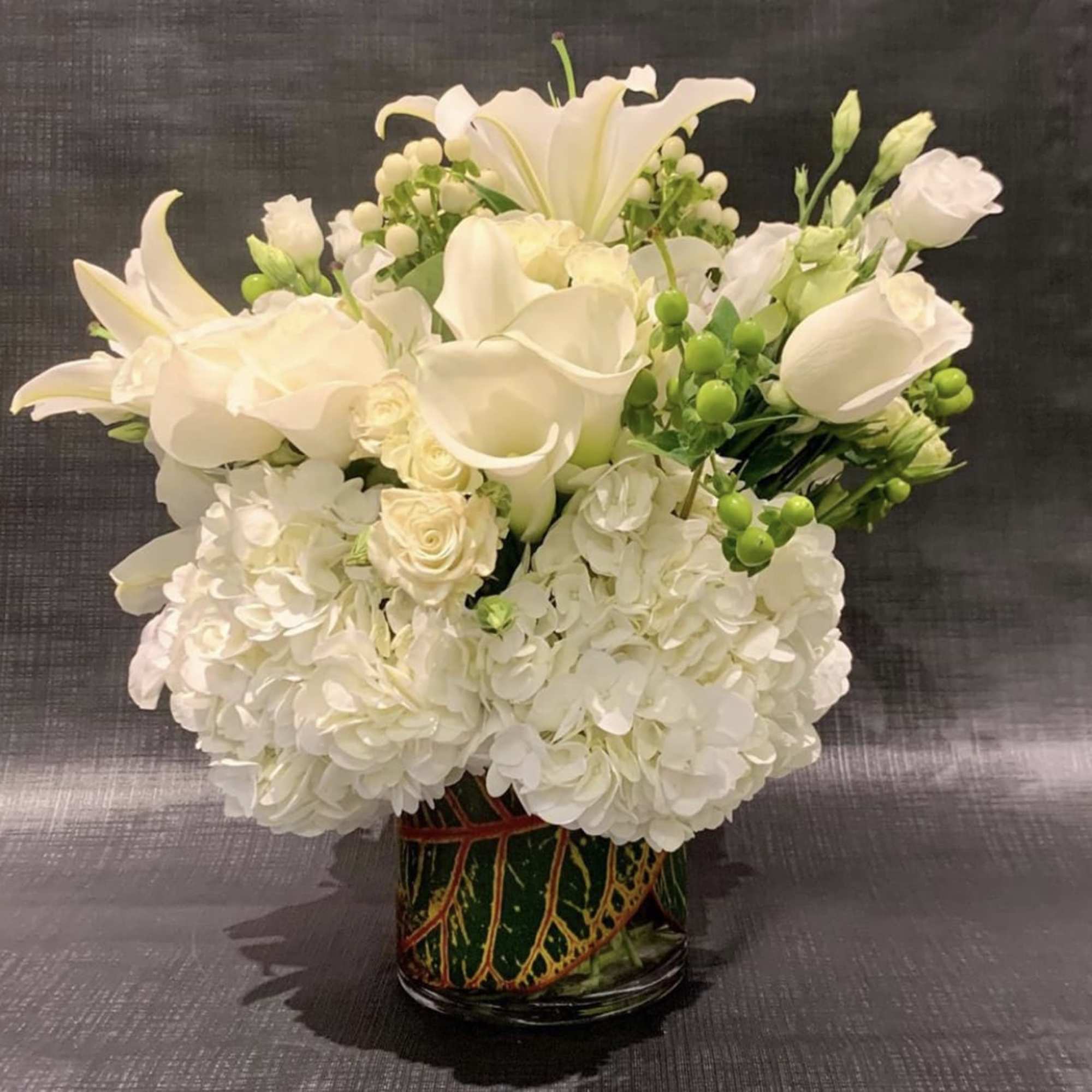 Custom Arrangement of hydrangea, white roses, Casablanca lilies, calla lilies, & lisianthus Custom Arrangement of hydrangea, white roses, Casablanca lilies, calla lilies, & lisianthus