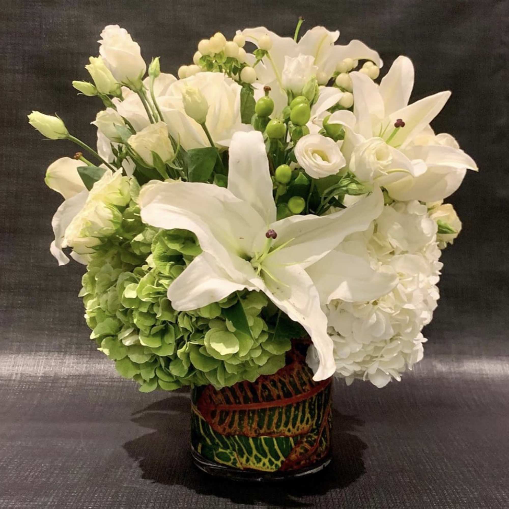 Custom Arrangement of hydrangea, white roses, Casablanca lilies, calla lilies, & lisianthus Custom Arrangement of hydrangea, white roses, Casablanca lilies, calla lilies, & lisianthus