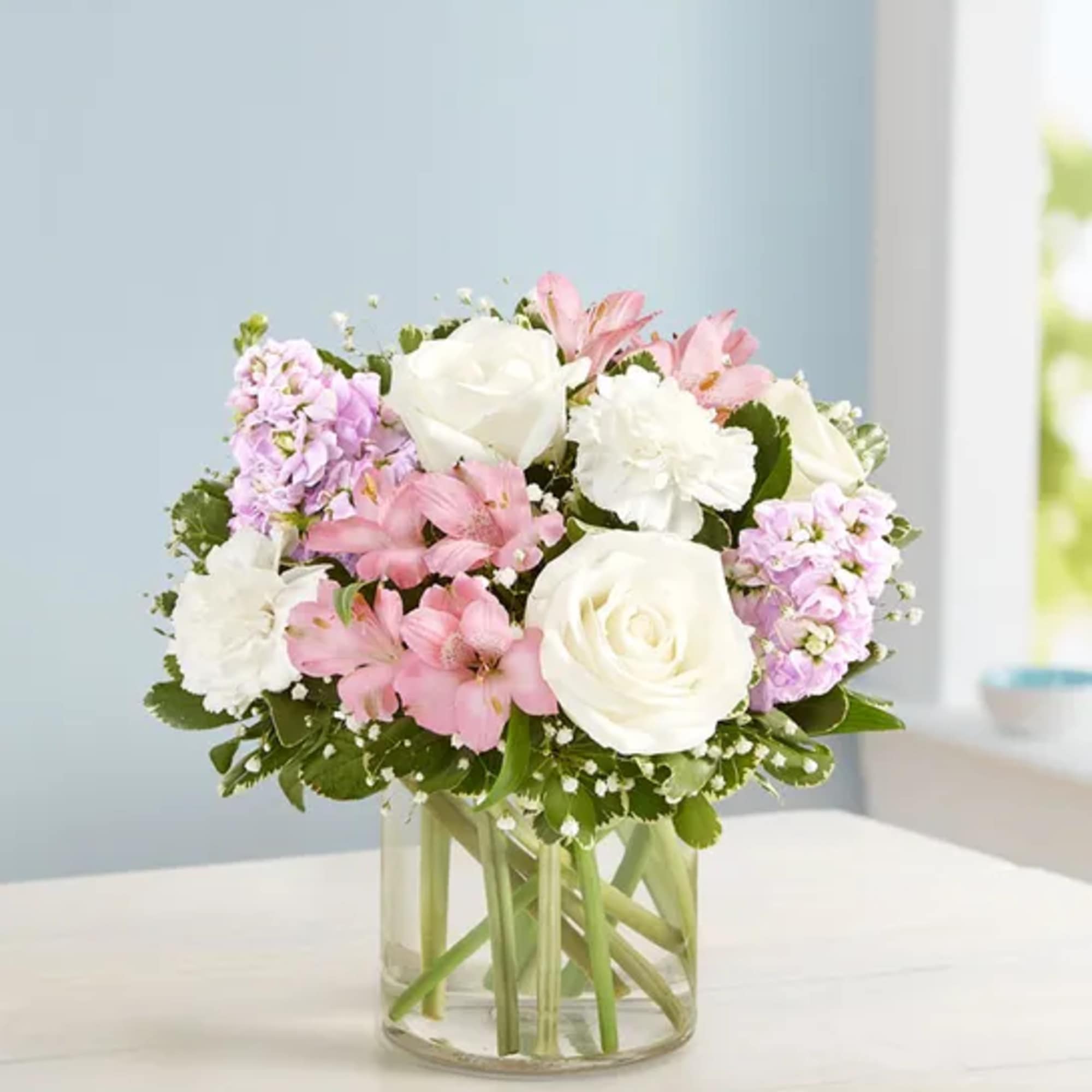 Our elegant bouquet in shades of blush pink and creamy white brings