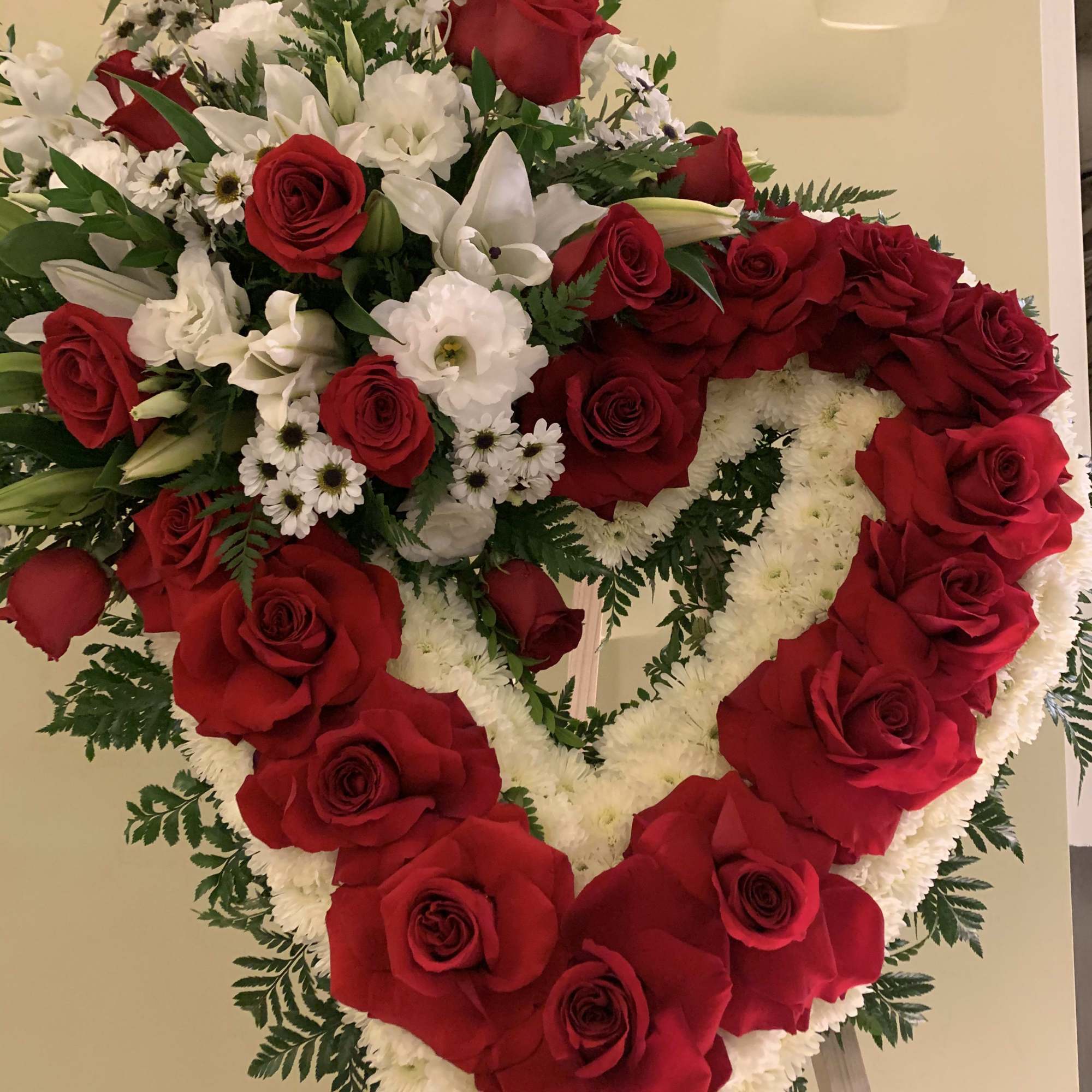 Red roses and white flowers makes this standing heart ,especial and memorable