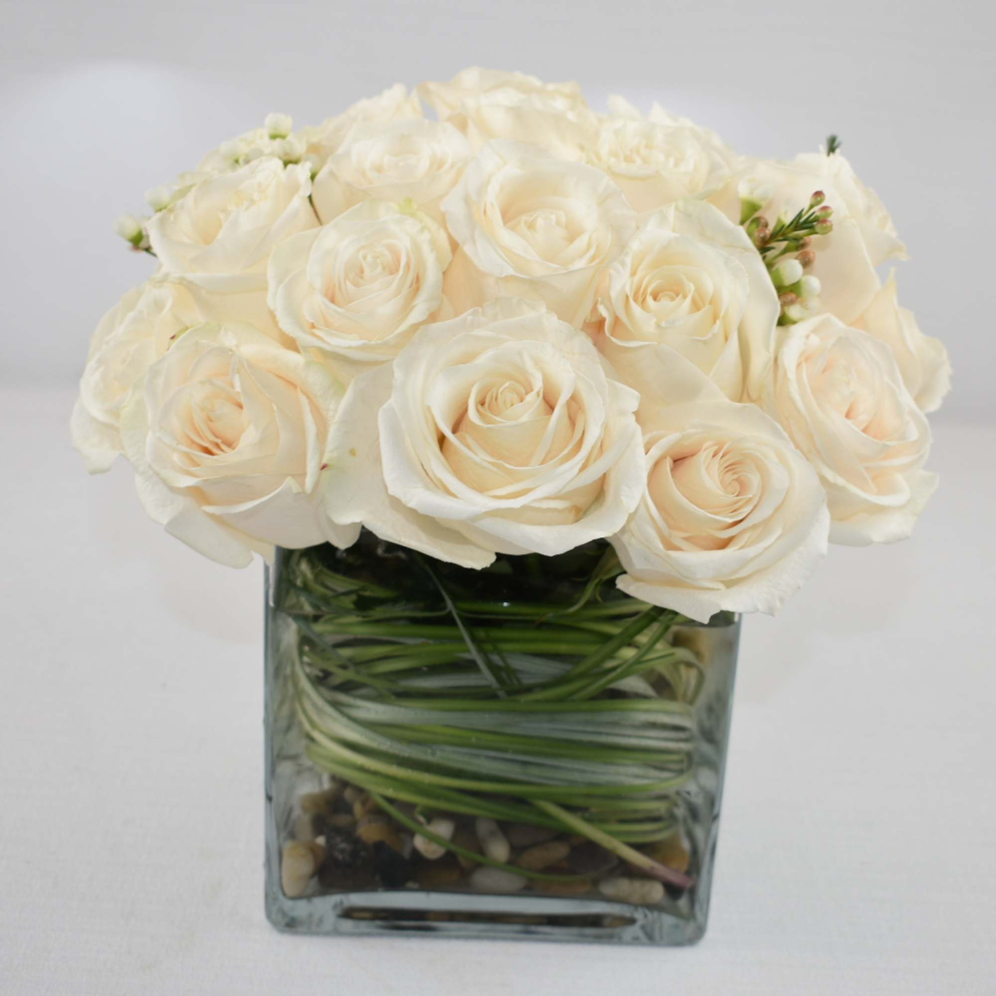 Lovely All white arrangement in a 6X6 clear square vase 
with 36