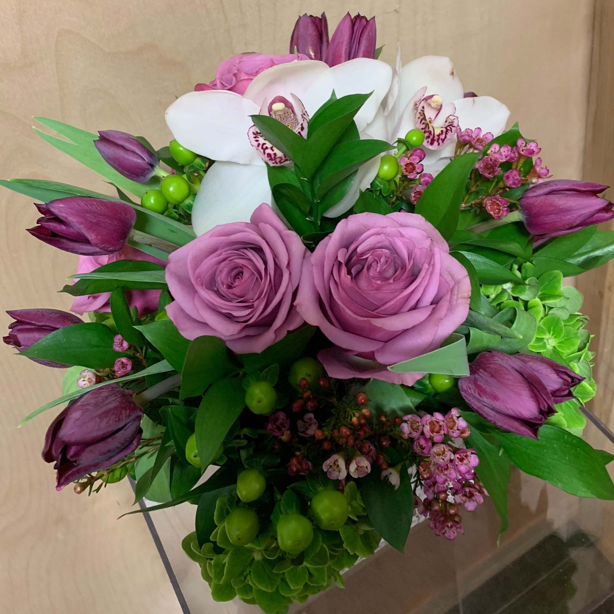 Rustic white ceramic vase 
Contains some beautiful purple tulips, Ecuadorian Lavender roses