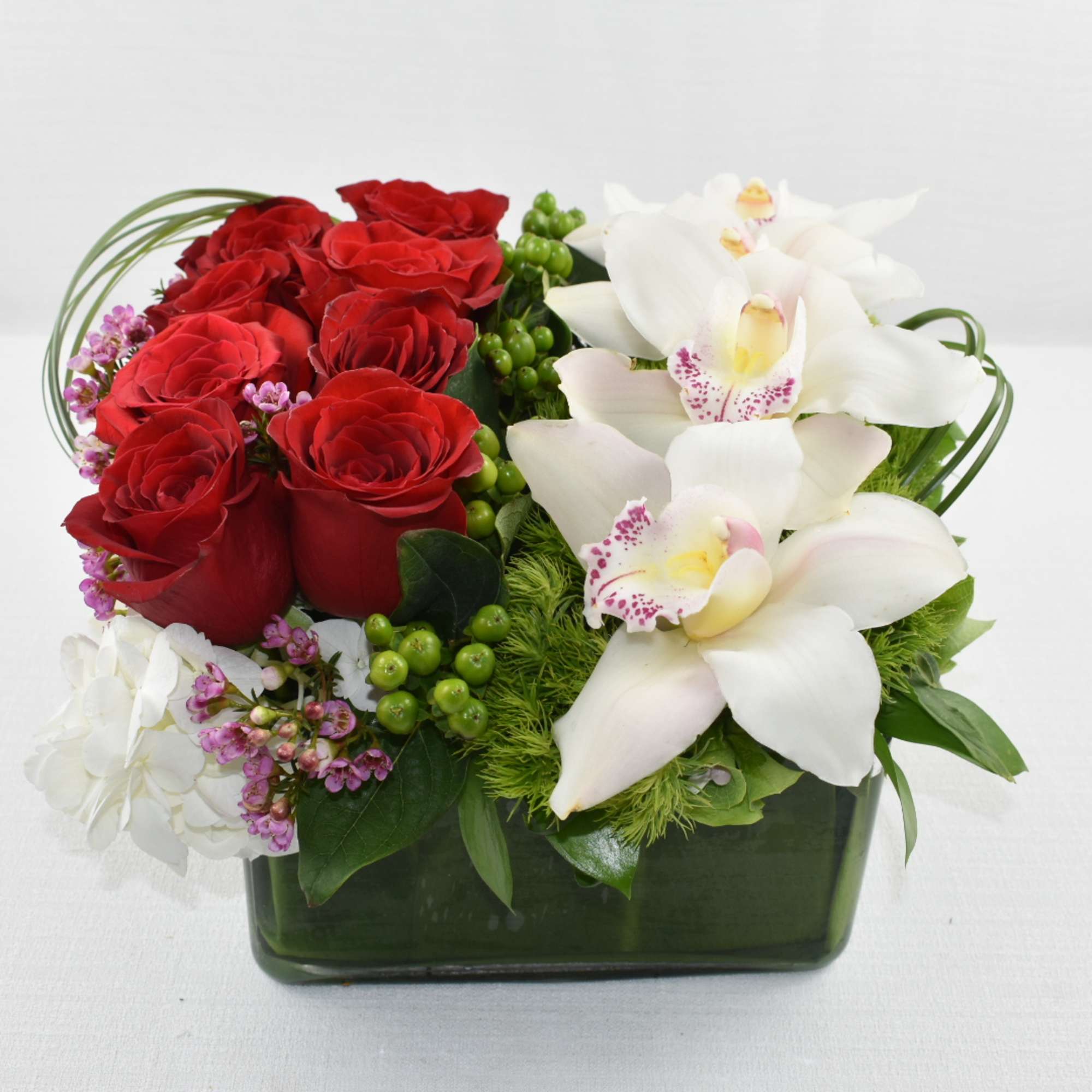 A unique Sebas Flowers design 
In a low square vase 
with 2