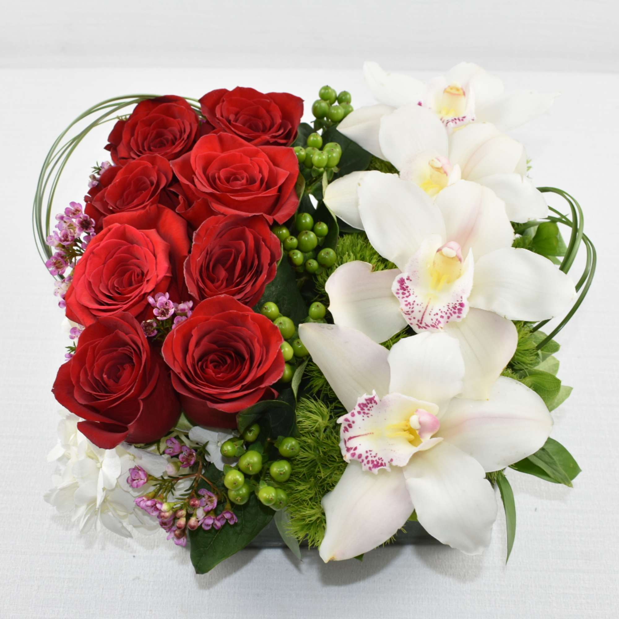 A unique Sebas Flowers design 
In a low square vase 
with 2